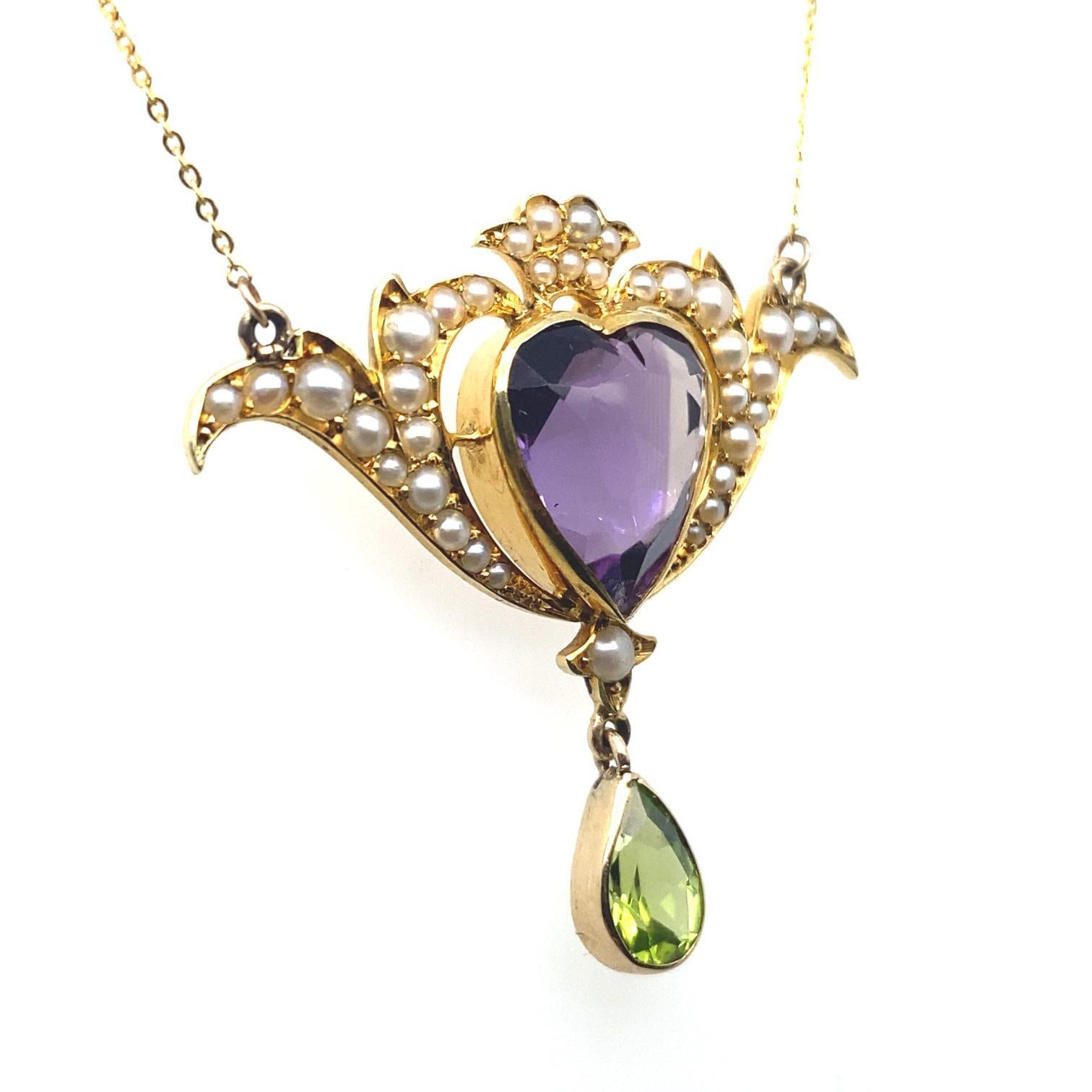 A Murrle Bennett & Co Art Nouveau amethyst and pearl yellow gold heart necklace.

A finely crafted 15 carat yellow gold pendant of swirling form, set to its centre with a heart shaped amethyst of 4 carats approximately of deep purple colour, with a