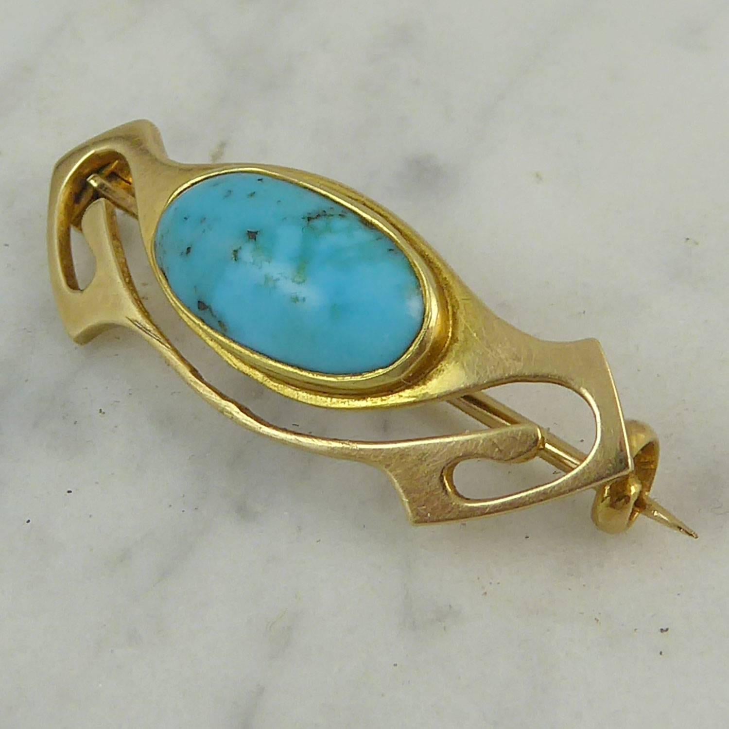 Delightful Art Nouveau brooch by the jewellery company, Murrle Bennett.  In typical Art Nouveau style and set with an oval cabochon cut turquoise in a raised surround to a yellow gold stylized plaque.  The reverse of the brooch bears the mark for