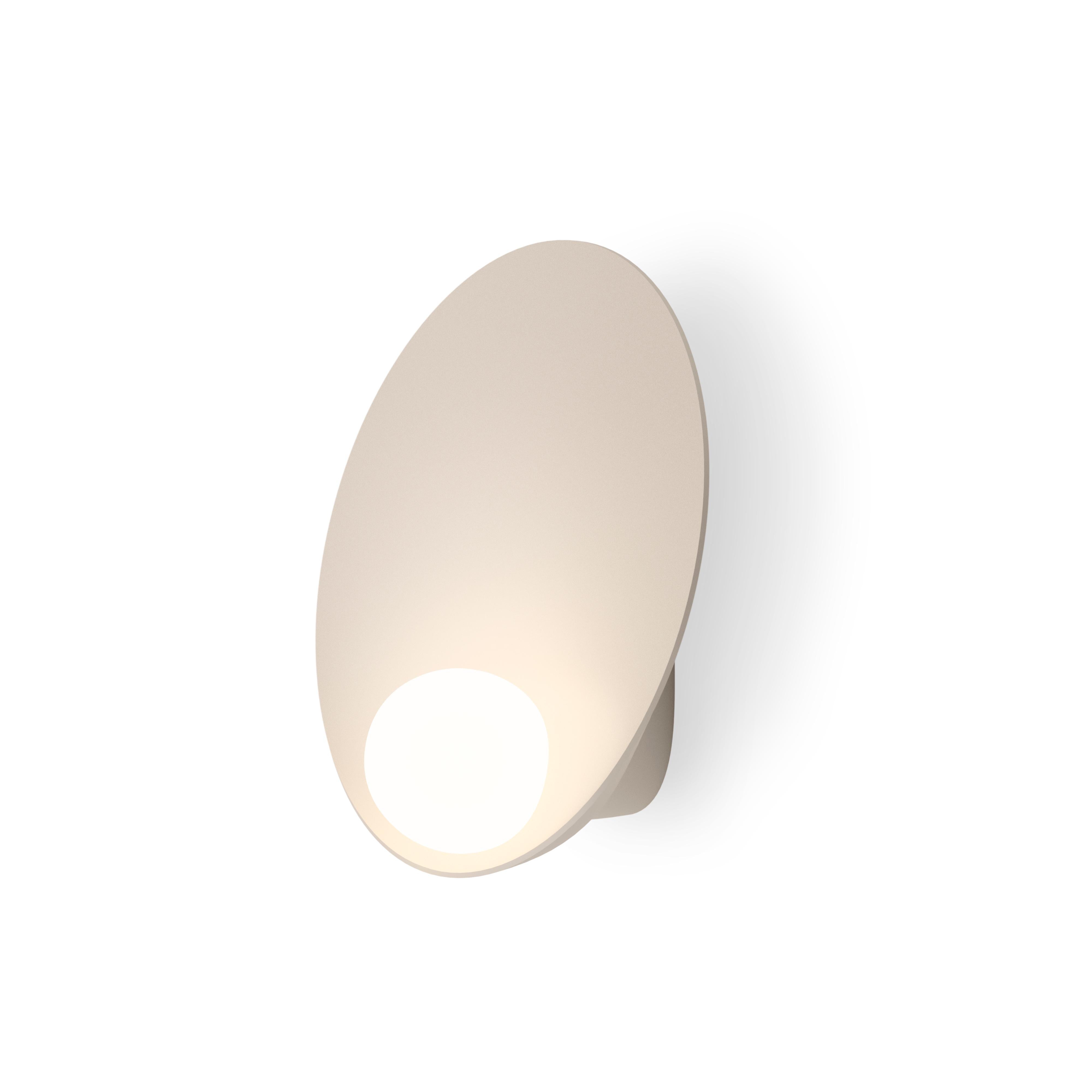 Musa, made from an aluminum base with a triple blown-glass opal diffuser, combines delicacy and subtlety. The base captures light as the small glass sphere transforms it into a soft illumination. The wall lamp remains cool to the touch thanks to an