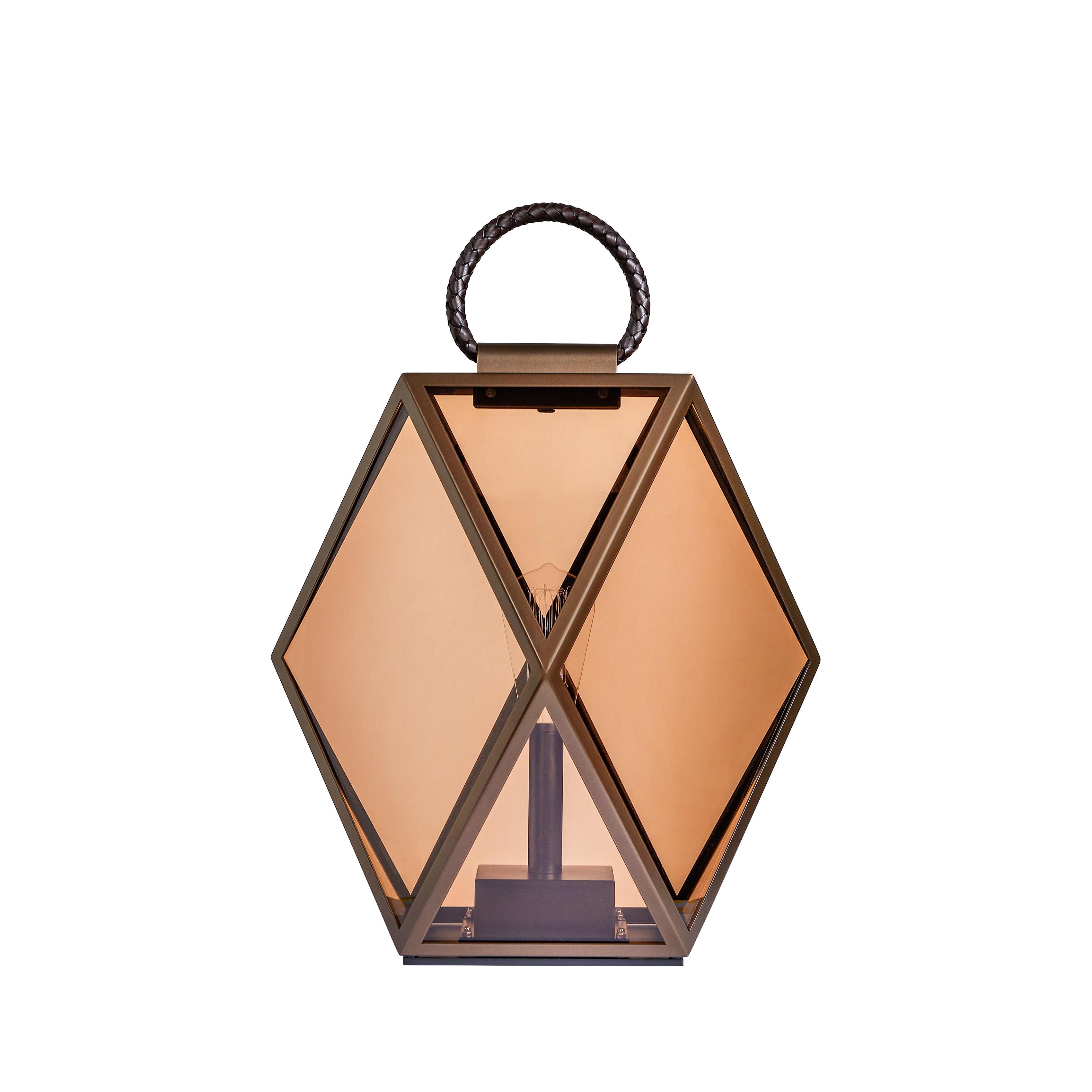 The bronze finish of Muse Lantern has been treated to resist in outdoor spaces and weathering, with a braided leather handle. The plastic diffuser in the Lantern version keep the transparent amber finish.
 