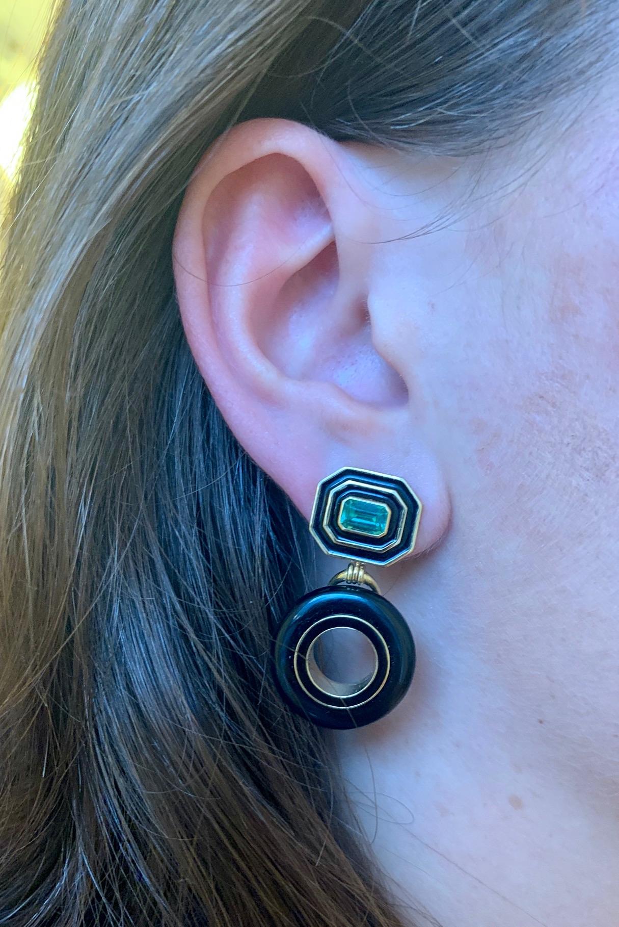 These Museum Donut Series Earrings by Andrew Glassford consist of 1.18 ctw of Brazilian Green Tourmalines. The top of the earring is set in the museum series style and mounted horizontally surrounded by two bands of enamel in 18K Yellow Gold. The