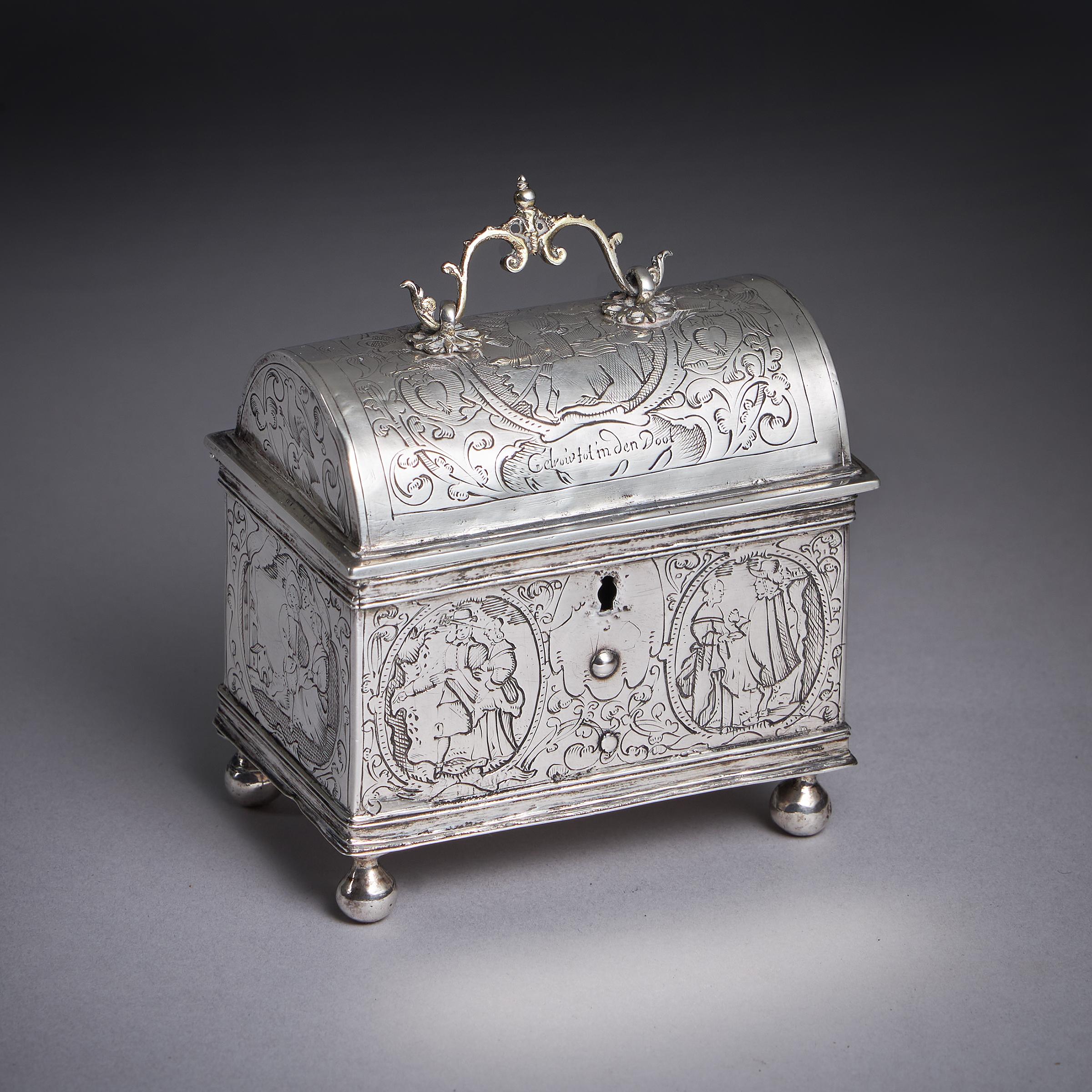 A museum-grade mid-17th century Dutch silver marriage casket or knottekistje, circa 1660.

Raised on solid silver bun feet the miniature casket is profusely engraved to all faces depicting a courting couple and architecture entwined in scrolling