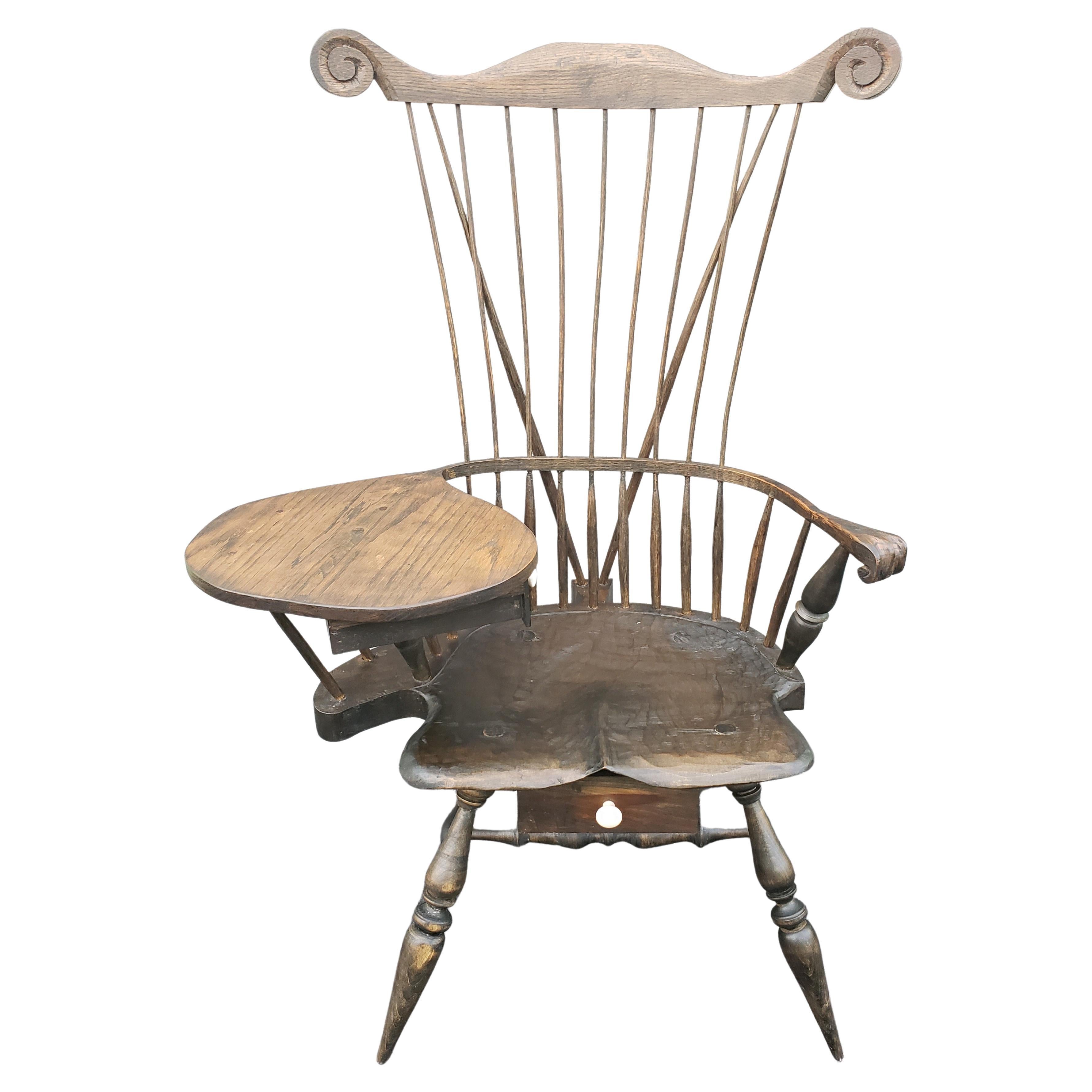 The Comb-Back, spindle and brace back Windsor Writing chair / Desk features a traditional sack-back style Windsor with a comb. It includes a hand sculpted saddle seat , with arms made of a single, steam-bent piece of wood. This particular piece uses