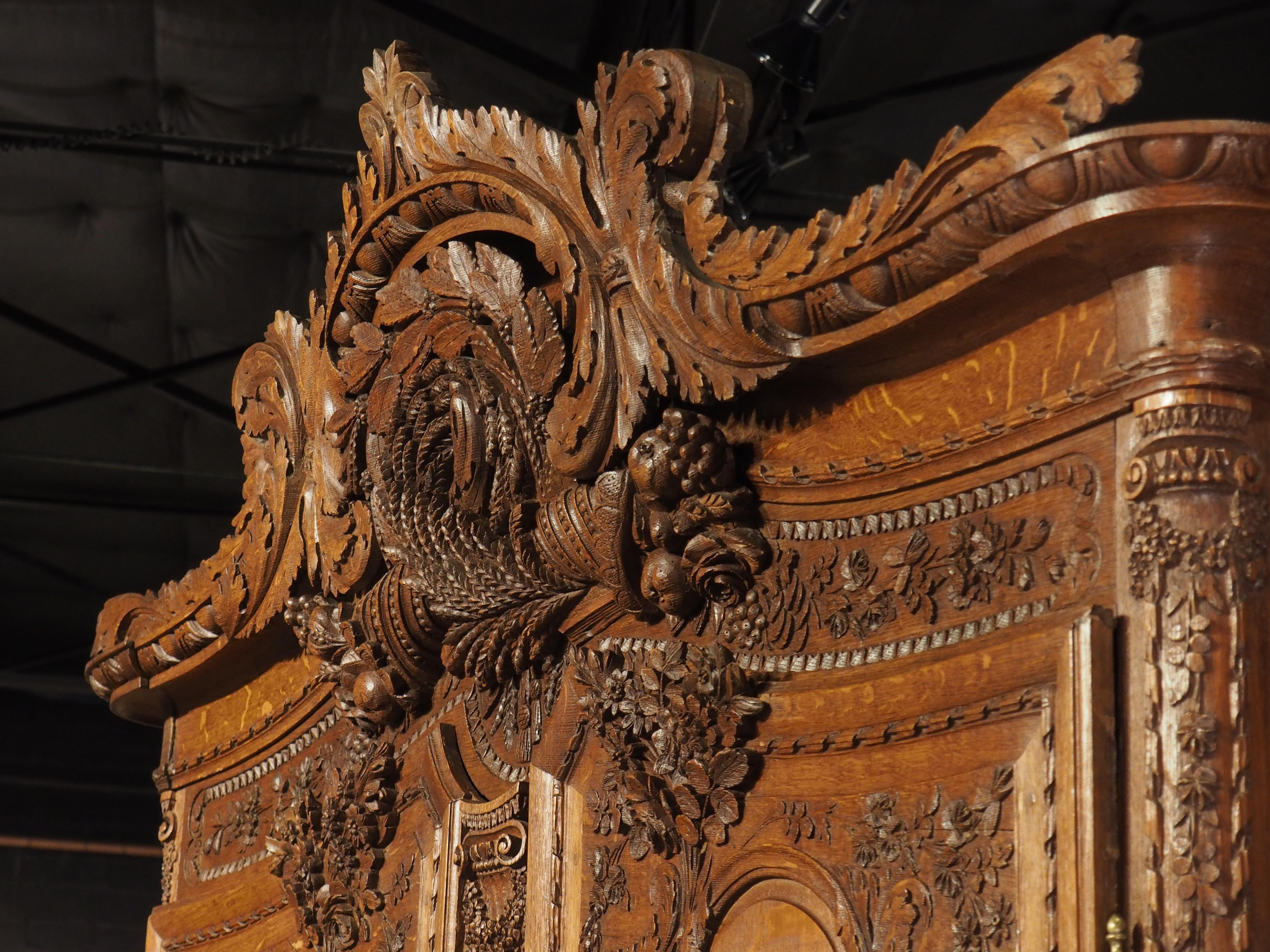 A magnificent example of furniture from Normandy, this French armoire is of museum quality. The 19th century armoire would have been given as a wedding dowry for a bride and based on the size and amount of detailed carvings, it was commissioned by a