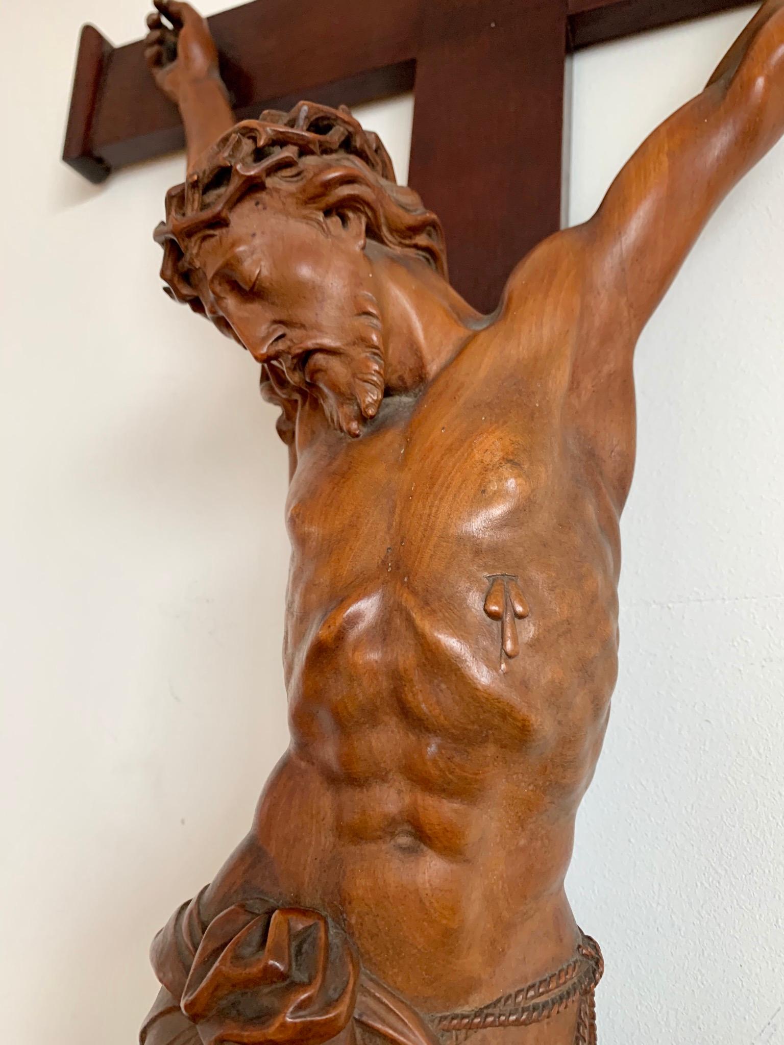 Large antique crucifix with stunning hand carved details and an amazing patina.

This remarkable and sizeable corpus of a deceased Christ on the cross is different to almost all others. The artist who hand-sculpted this impressive work of