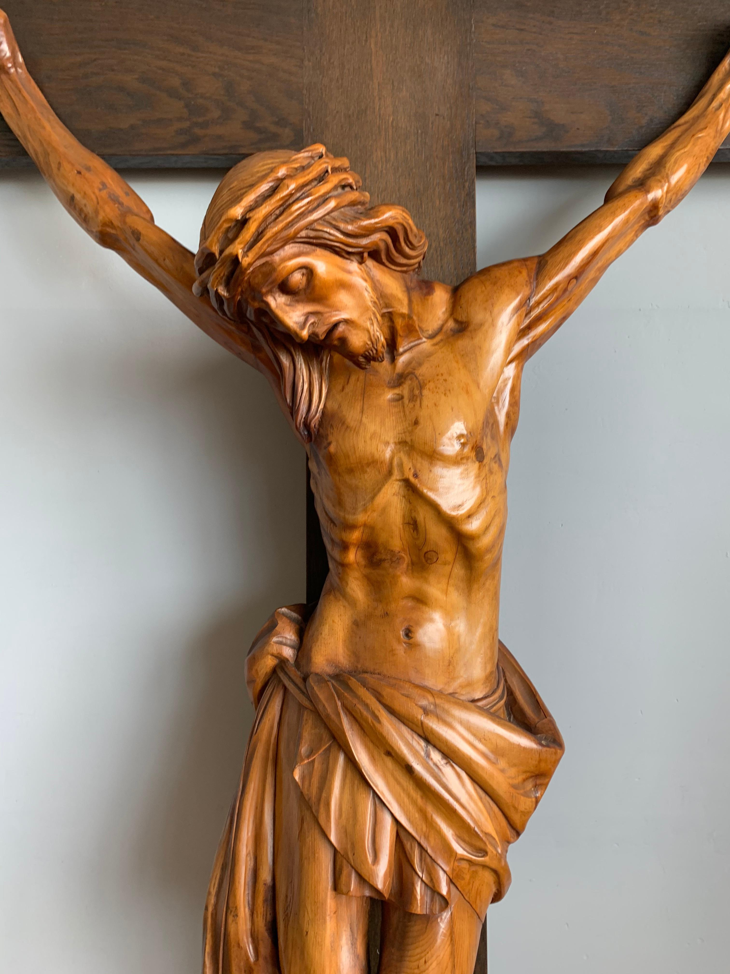 Large antique crucifix with stunning hand carved details and an amazing patina.

This remarkable and large corpus of a deceased Christ on the cross is different to almost all others. The artist who hand-sculpted this impressive work of religious art