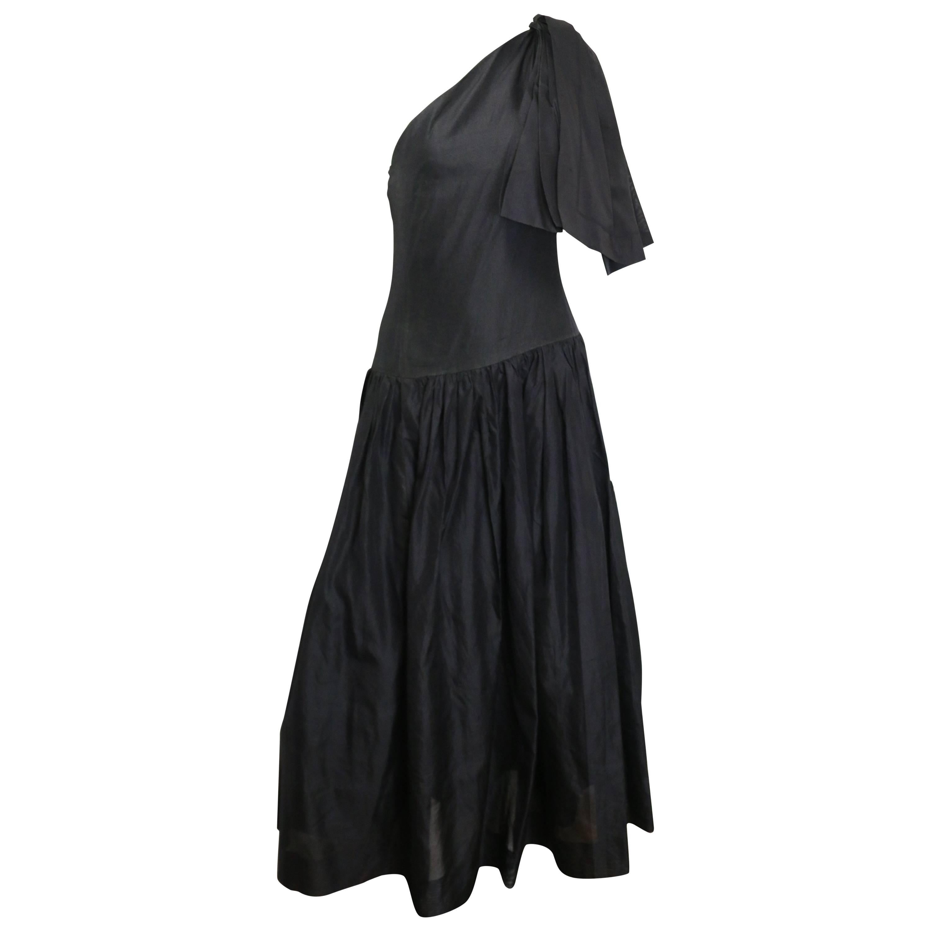 - Vintage Chanel black silk taffeta one shoulder evening gown from circa late 80s collection. 

- Pleated shoulder and bottom part of the dress. 

- Two layers. 

- Side zipper closure. 

- Three hooks closure on the shoulder. 

- Fair vintage