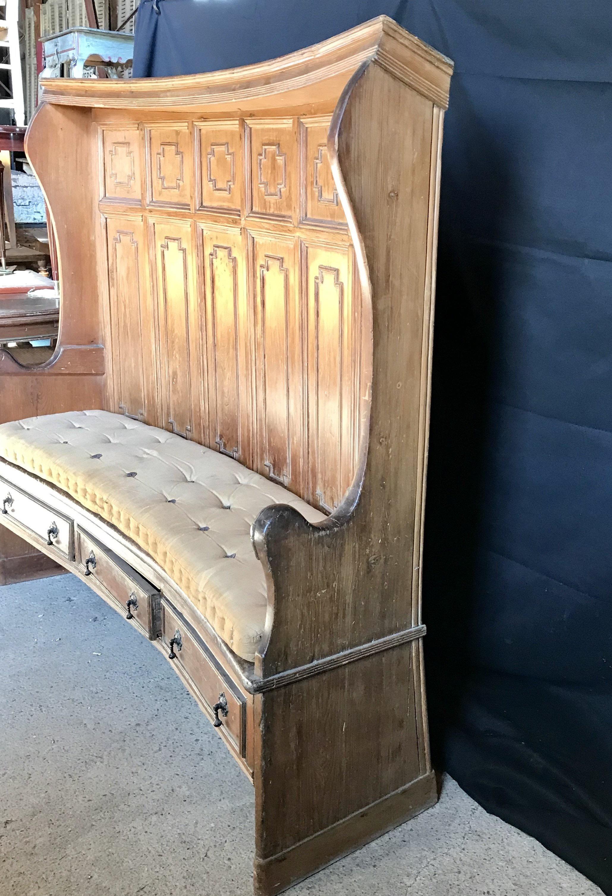 Very early British antique Georgian tavern settle with two sided paneling and original leather buttoned cushion. Perfect for a hall storage bench, this museum quality piece features a beautiful tall curved form, remarkable patina, three storage