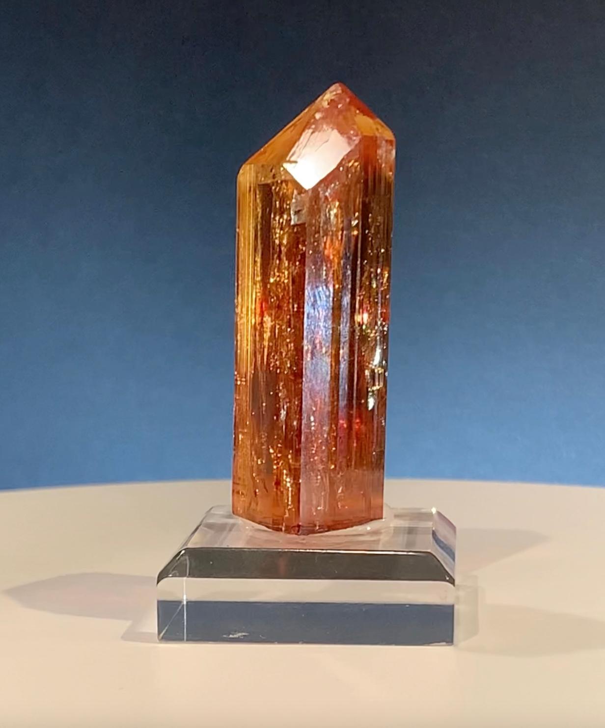 This unbelievable 81 gram (base included) imperial topaz from Ouro Preto, Brazil – where most of the world's rare, true orange-red imperial topazes are sourced – features a flawless termination, absolutely astonishing color, and great luster. Pieces
