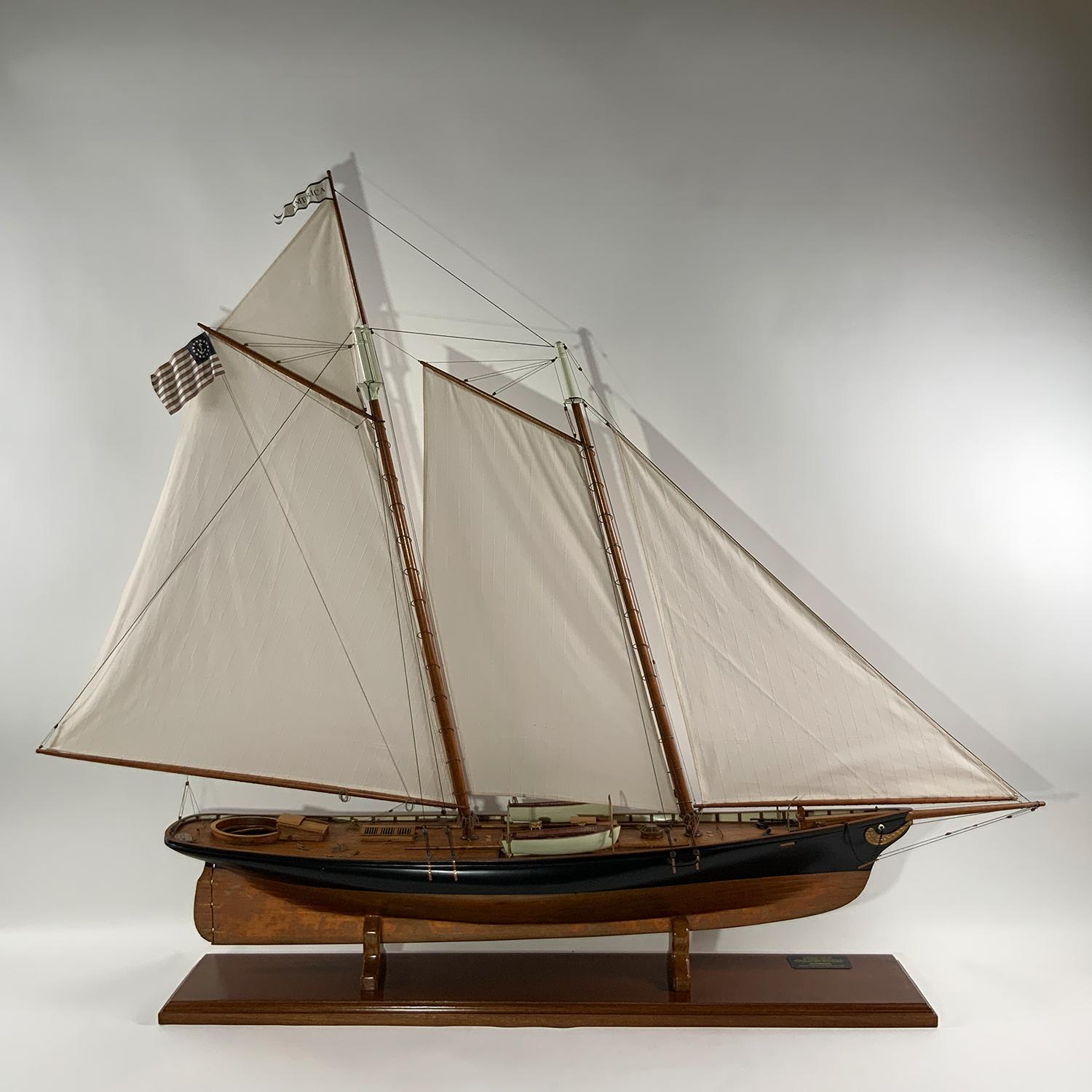 Five and a half foot precision scale model of the America's Cup Yacht America of 1851. Sleek hull is copper sheathed below the waterline down. Planked and varnished mahogany deck. Rigged with a full suit of sails. Circa 2000.