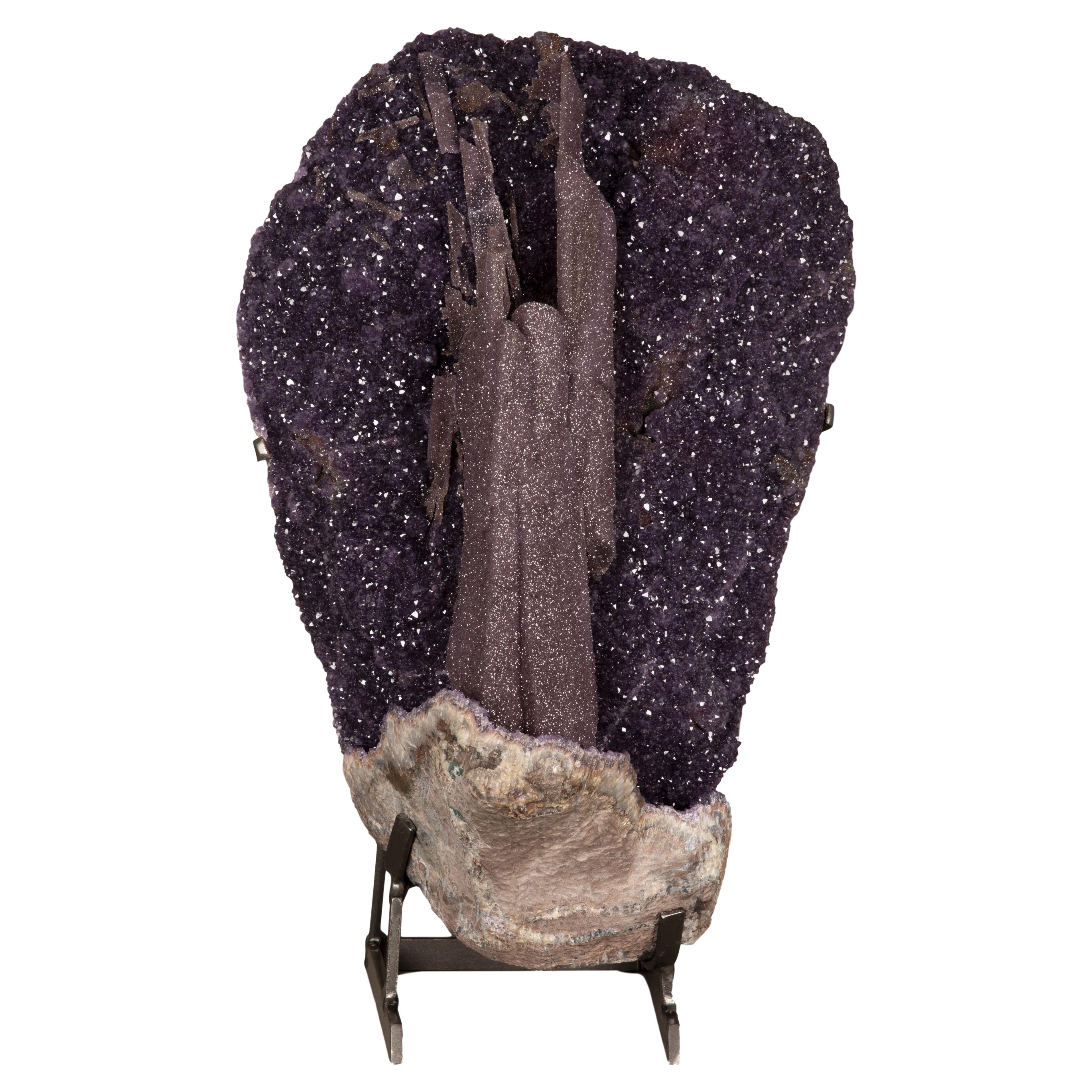 A very large, one of a kind epimorph amethyst. This piece is a visual
spectacle with the natural sculptural formations of amethyst in a different
variety of purple tones. Also displaying some quartz specimens in brown
orange druze.

An epimorph