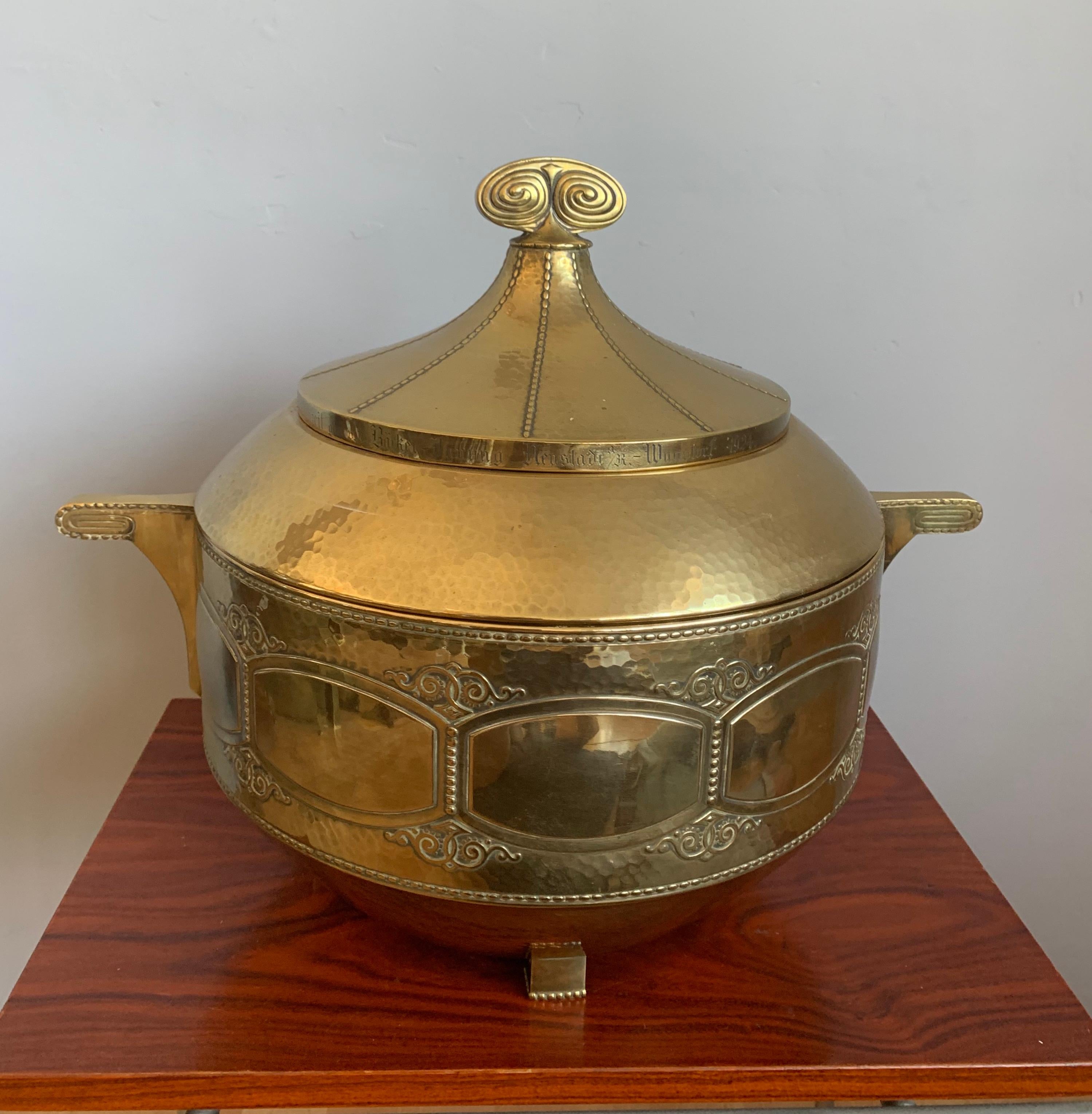 Large modernist design brass bowl with glass vessel and lid.

This unique and all handcrafted punchbowl from the Arts & Crafts era is another one of our recent great finds. Pieces from this era of top quality workmanship never seize to amaze us and