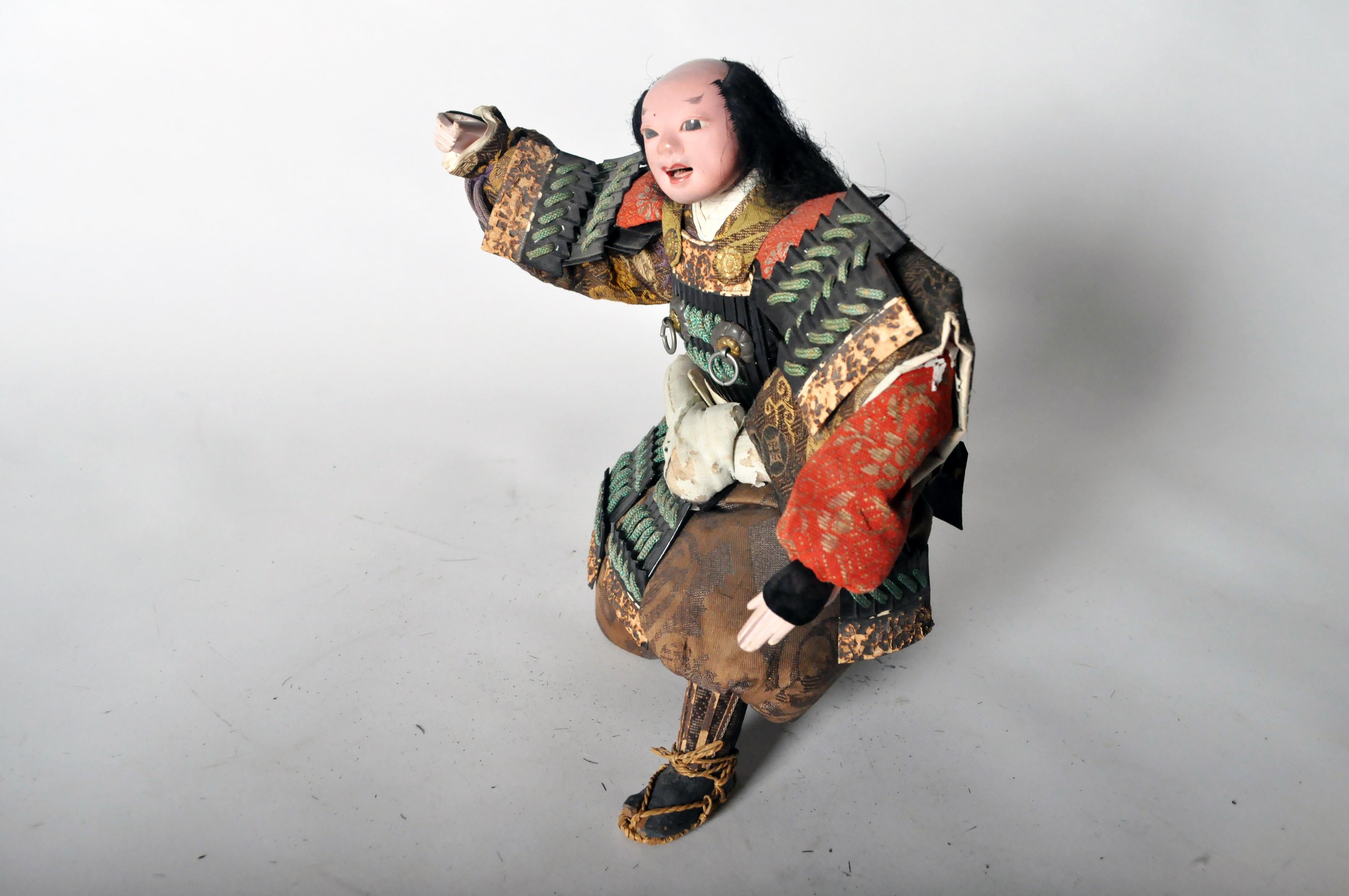 This Musha Samurai warrior figure is from Japan and made from silk and wood, circa 1850. The samurai were the military nobility and officer caste of medieval and early-modern Japan. In Japanese, they are usually referred to as bushi or buke. By the