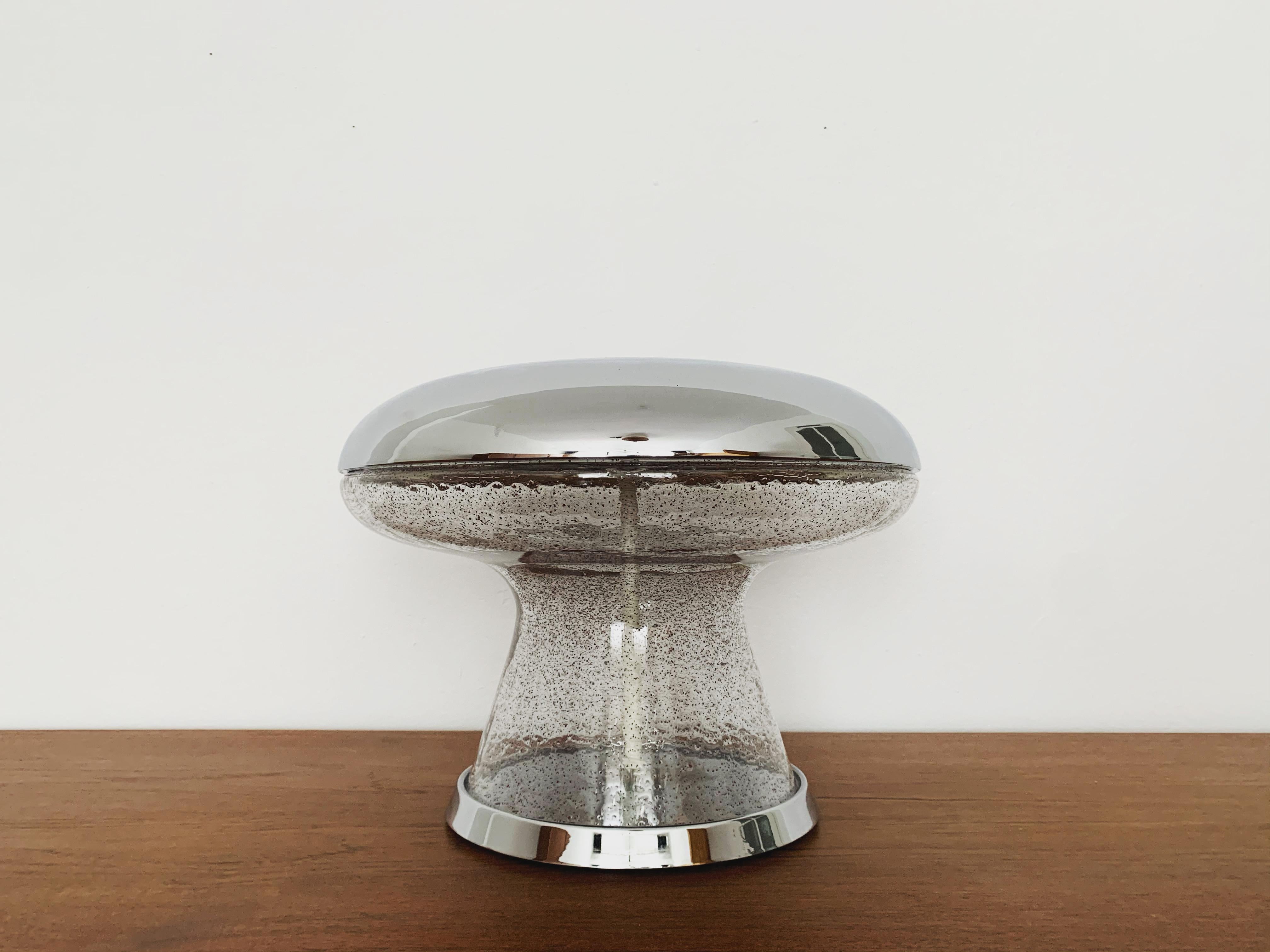 Very beautiful and high-quality ice glass table lamp from the 1960s.
The lamp is very noble and a very special design object.
The red inclusions in the glass create a very sparkling light.

Condition:

Very good vintage condition with slight signs