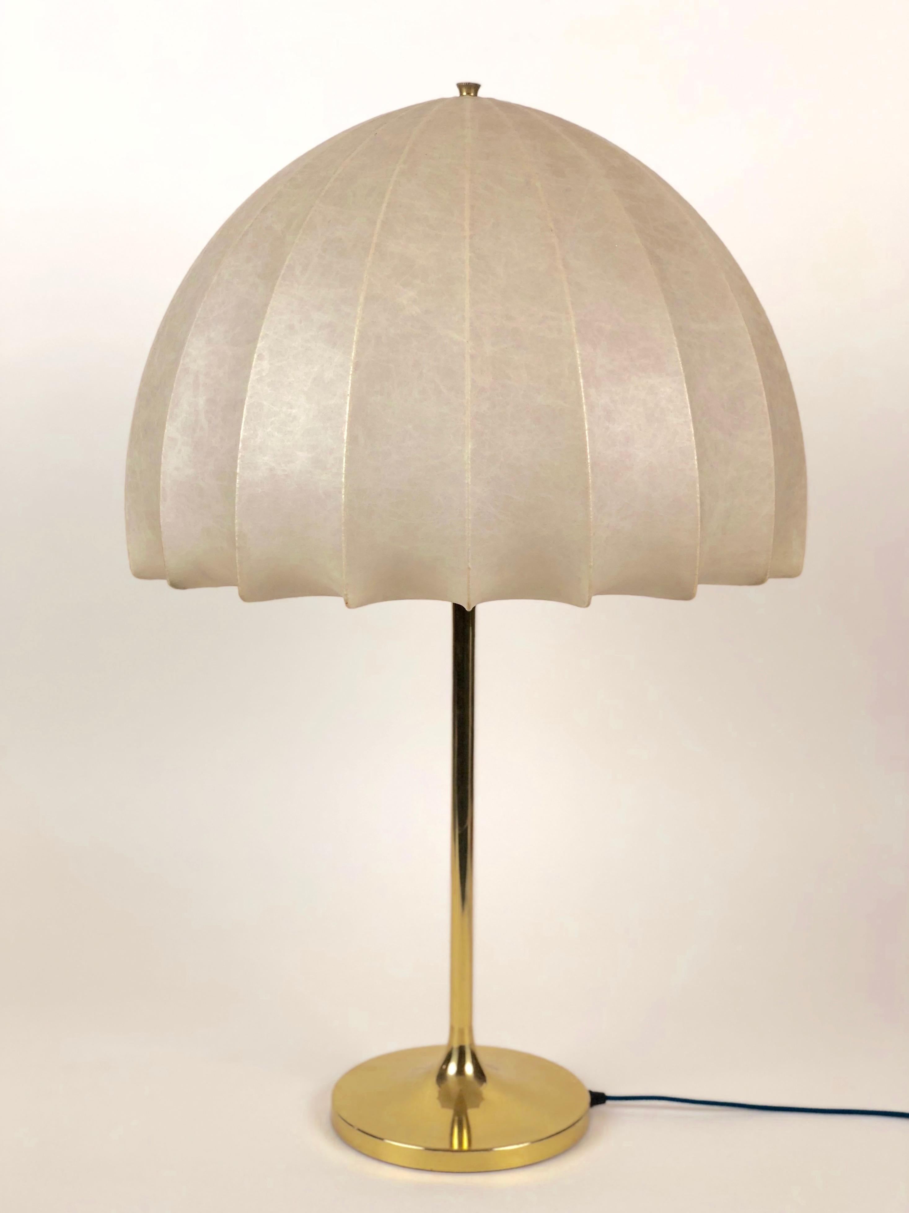 Mushroom styled lamp made in the 1970s with a soft synthetic skin and a tall brass stand. There are no holes tears in the skin.
The lamp has been newly rewired and has a cloth covered cable.