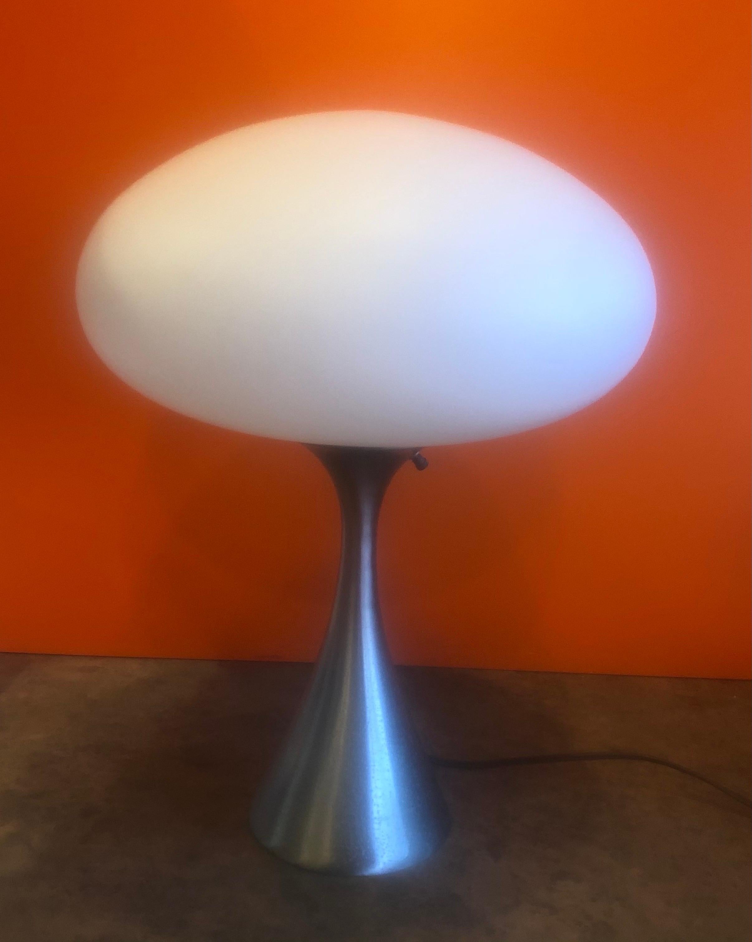Stylistic mushroom lamp with brushed aluminum base and matte glass shade by Laurel Lamp Company, circa 1950s. The base has a brushed aluminum finish that has been polished and the frosted lampshade is made of blown glass from Italy. Classic MCM