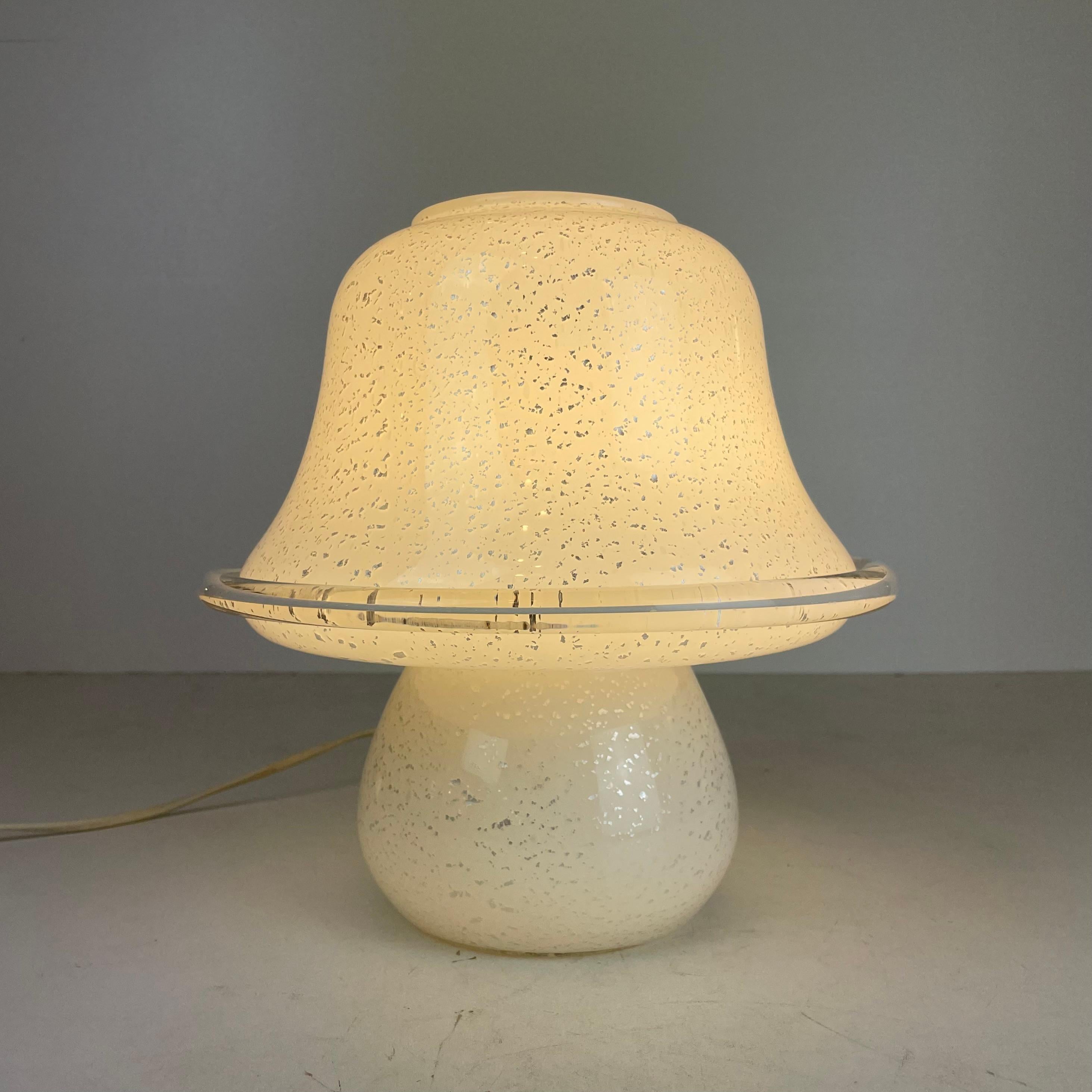 Cute mushroom-shaped table lamp with silver flakes inlaid in white translucent Murano glass.
-
Produced in: Murano Island, Venice, Italy
Design period: 1980s
Materials: Murano glass, 1000/1000 silver leaf
Color: white, silver
Dimensions: H 27 x D 25