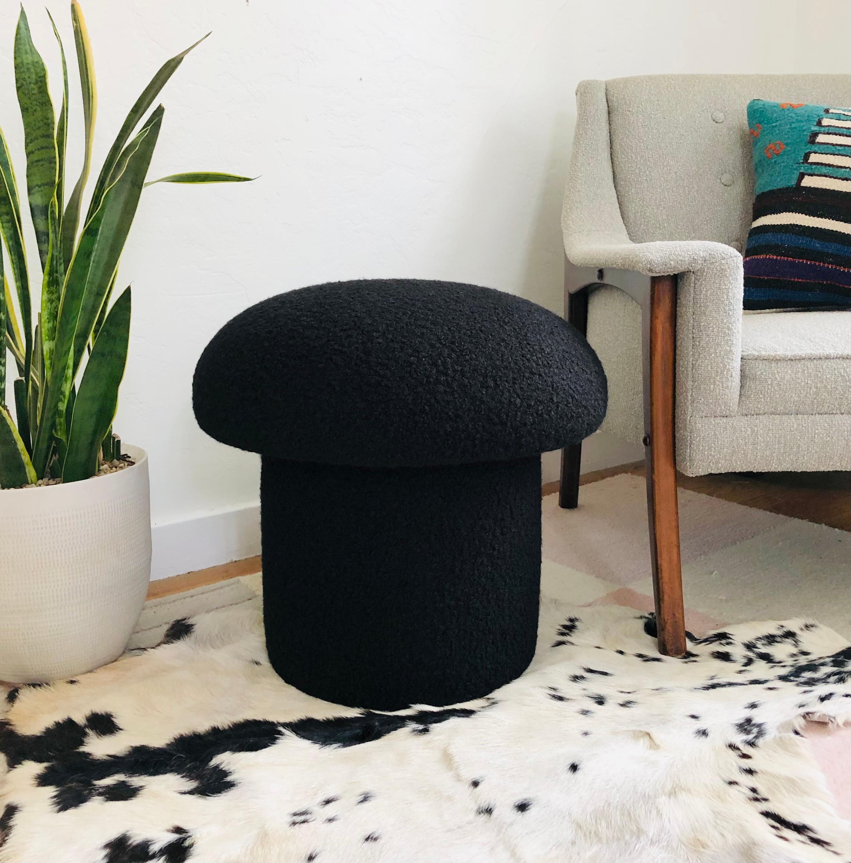 A handmade mushroom shaped ottoman, upholstered in a black curly boucle fabric. Perfect for using as a footstool or extra occasional seating. A comfortable cushioned seat and sculptural accent piece.
Mushroom ottomans are made to order,