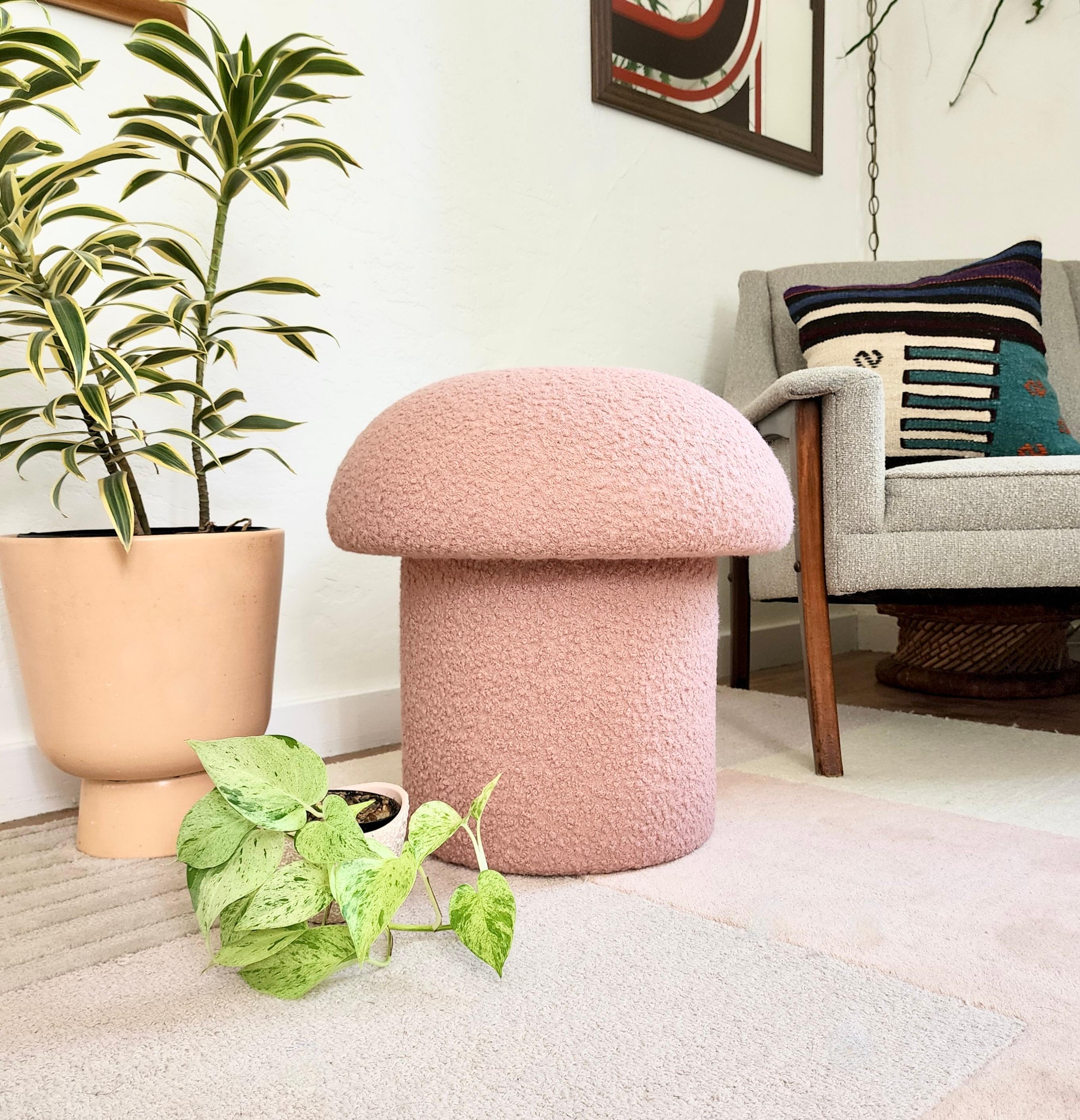 A handmade mushroom shaped stool, upholstered in a light pink colored curly boucle fabric. Perfect for using as a footstool or extra occasional seating. A comfortable cushioned seat and sculptural accent piece.
Mushroom ottomans are made to order,