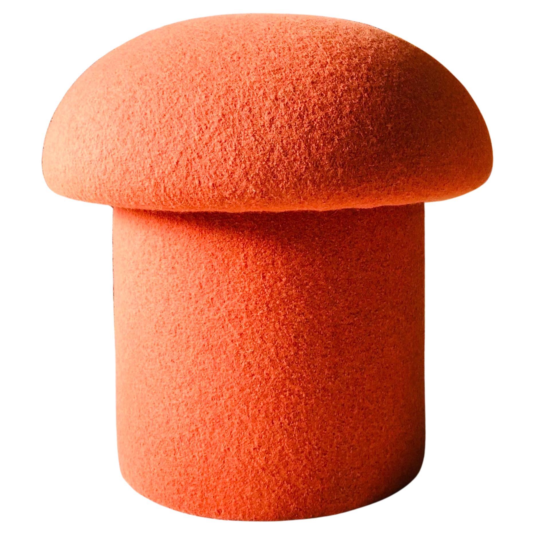 A handmade mushroom shaped ottoman, upholstered in 