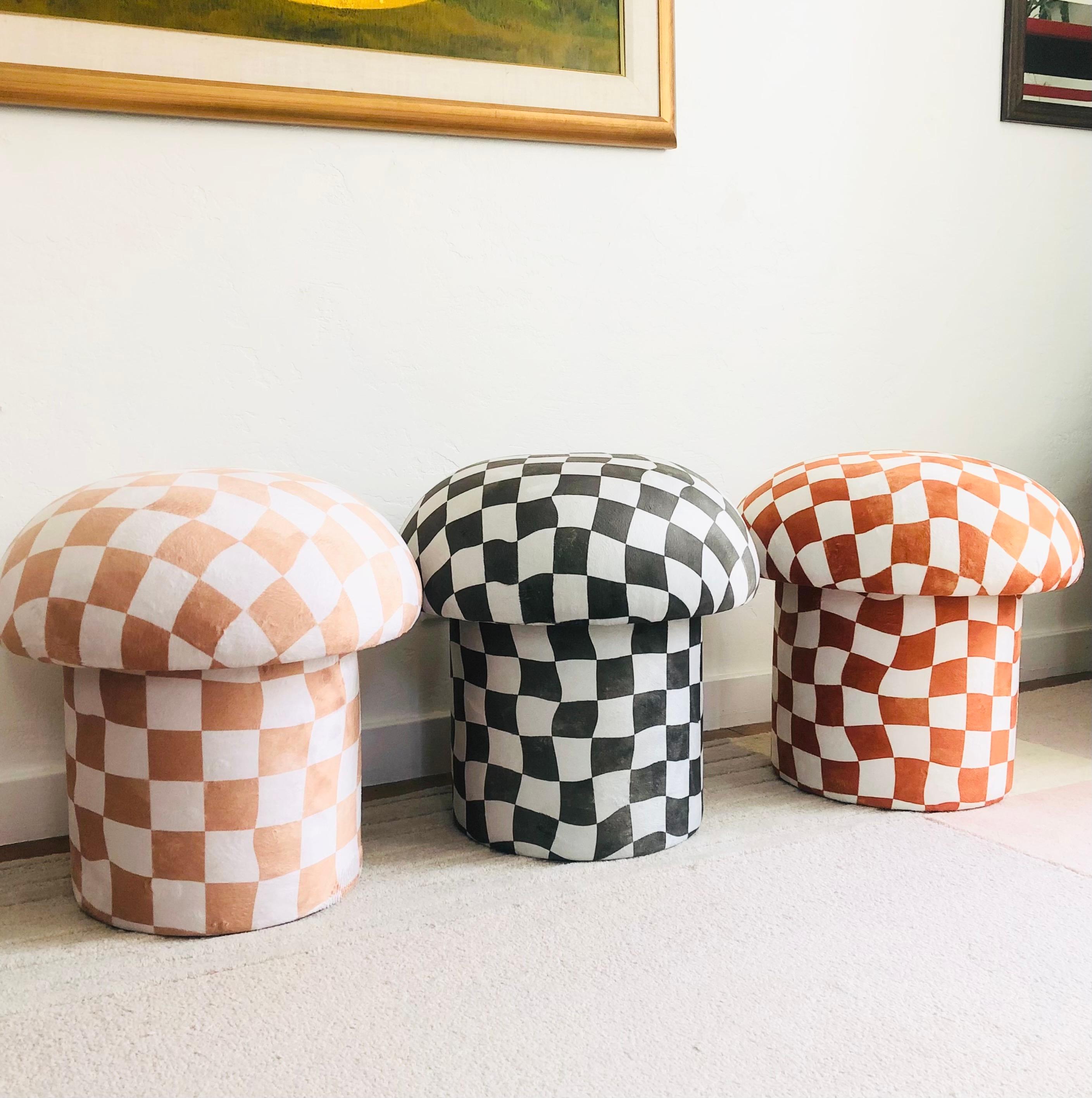 A handmade mushroom shaped ottoman, upholstered in a muted olive and a greenish off-white warped checkerboard velvet fabric. Perfect for using as a footstool or extra occasional seating. A comfortable cushioned seat and sculptural accent