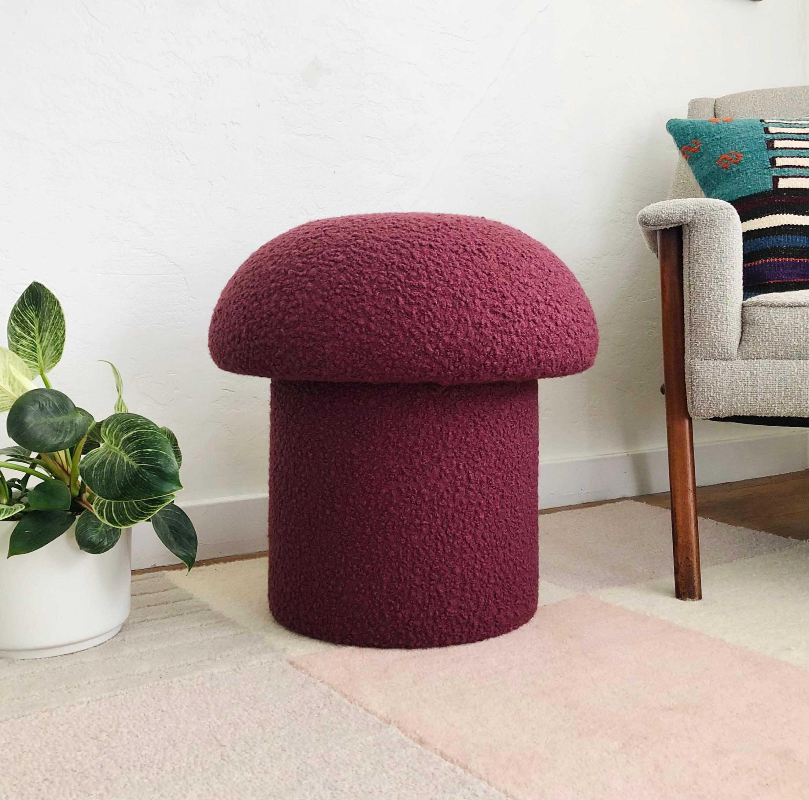 A handmade mushroom shaped ottoman, upholstered in an orchid colored curly boucle fabric. Orchid is a muted purple color. Perfect for using as a footstool or extra occasional seating. A comfortable cushioned seat and sculptural accent