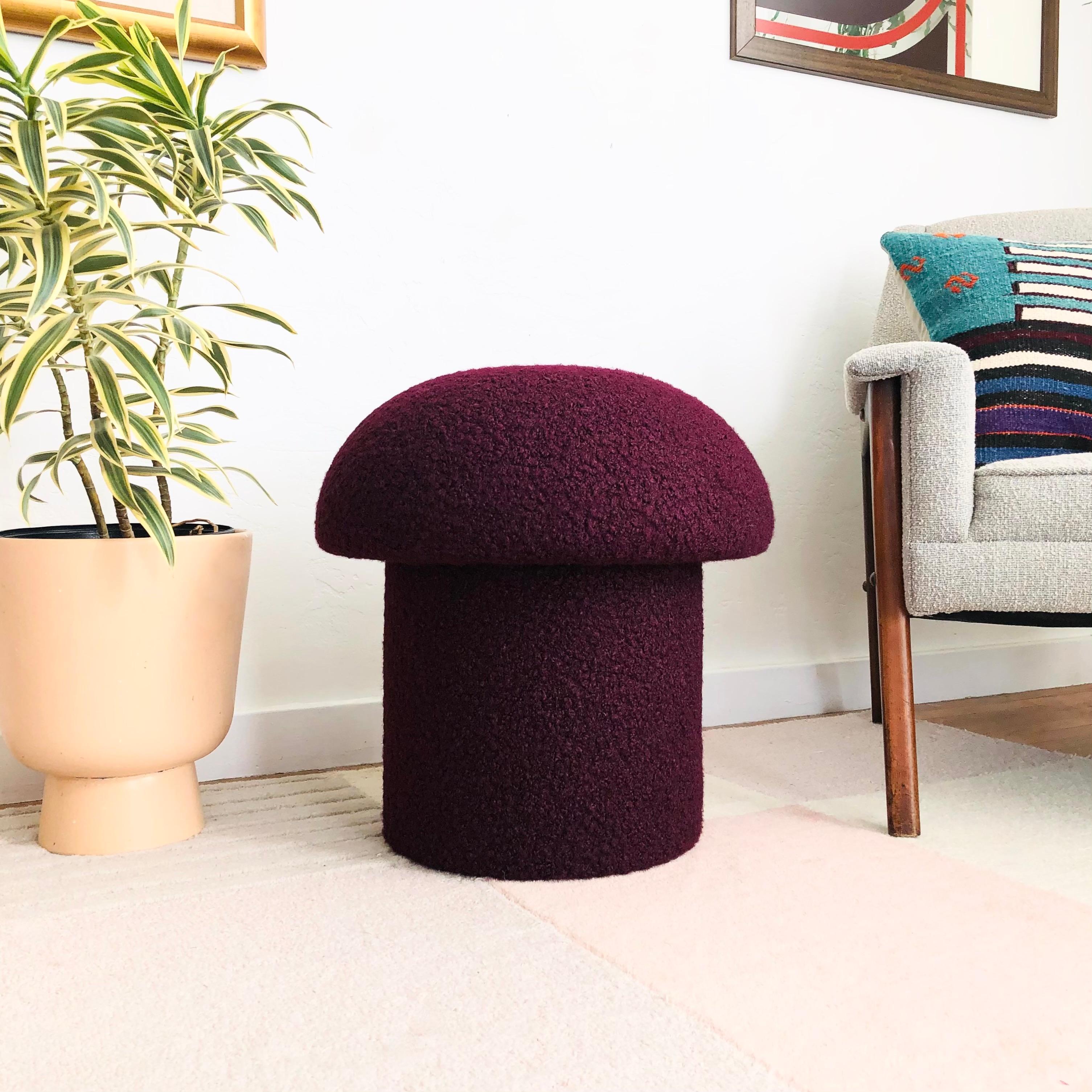 A handmade mushroom shaped ottoman, upholstered in a plum colored curly boucle fabric. Perfect for using as a footstool or extra occasional seating. A comfortable cushioned seat and sculptural accent piece.
Mushroom ottomans are made to order,
