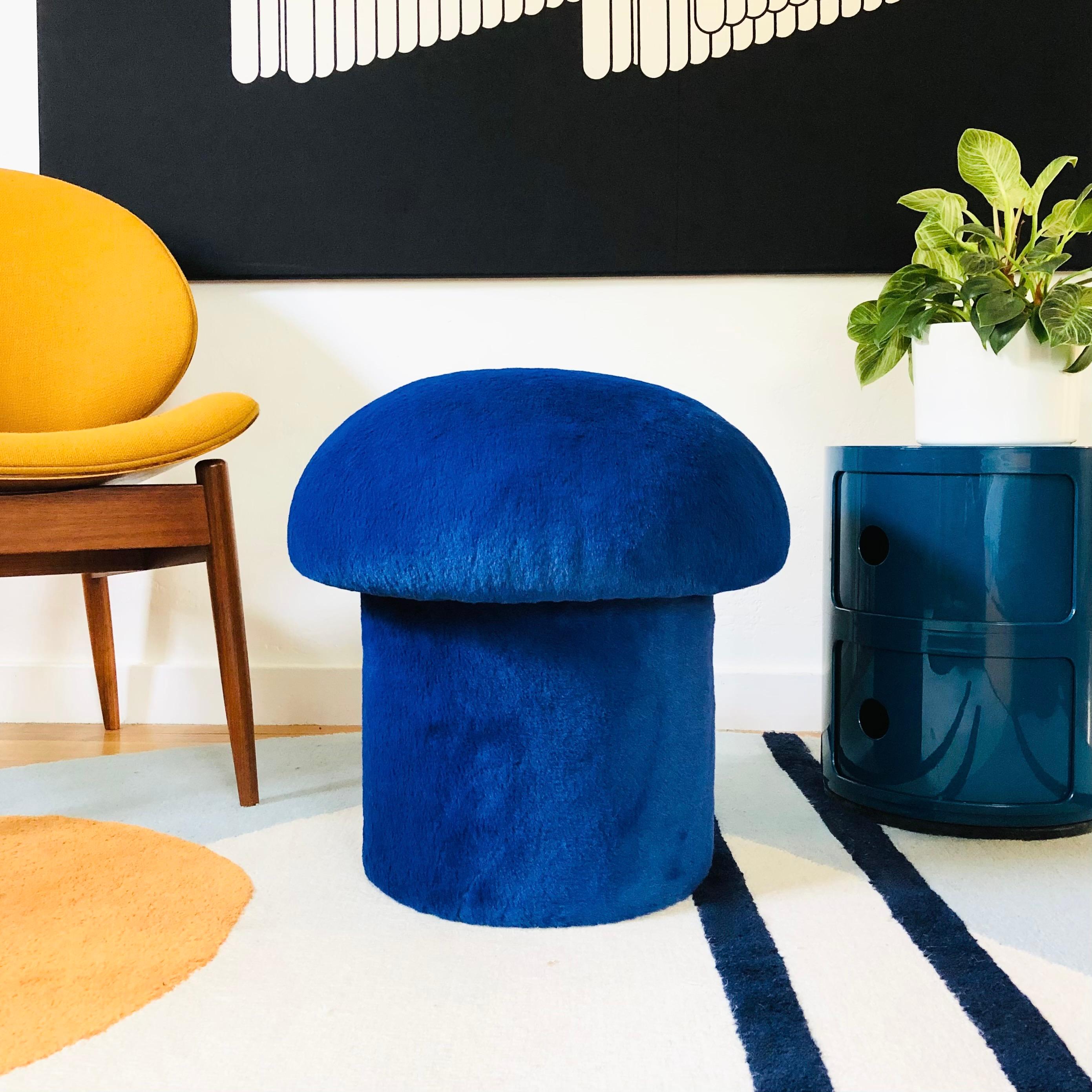 A handmade mushroom shaped ottoman, upholstered in a sapphire colored high pile plush fabric. Perfect for using as a footstool or extra occasional seating. A comfortable cushioned seat and sculptural accent piece.
PLEASE NOTE:
Color variations may