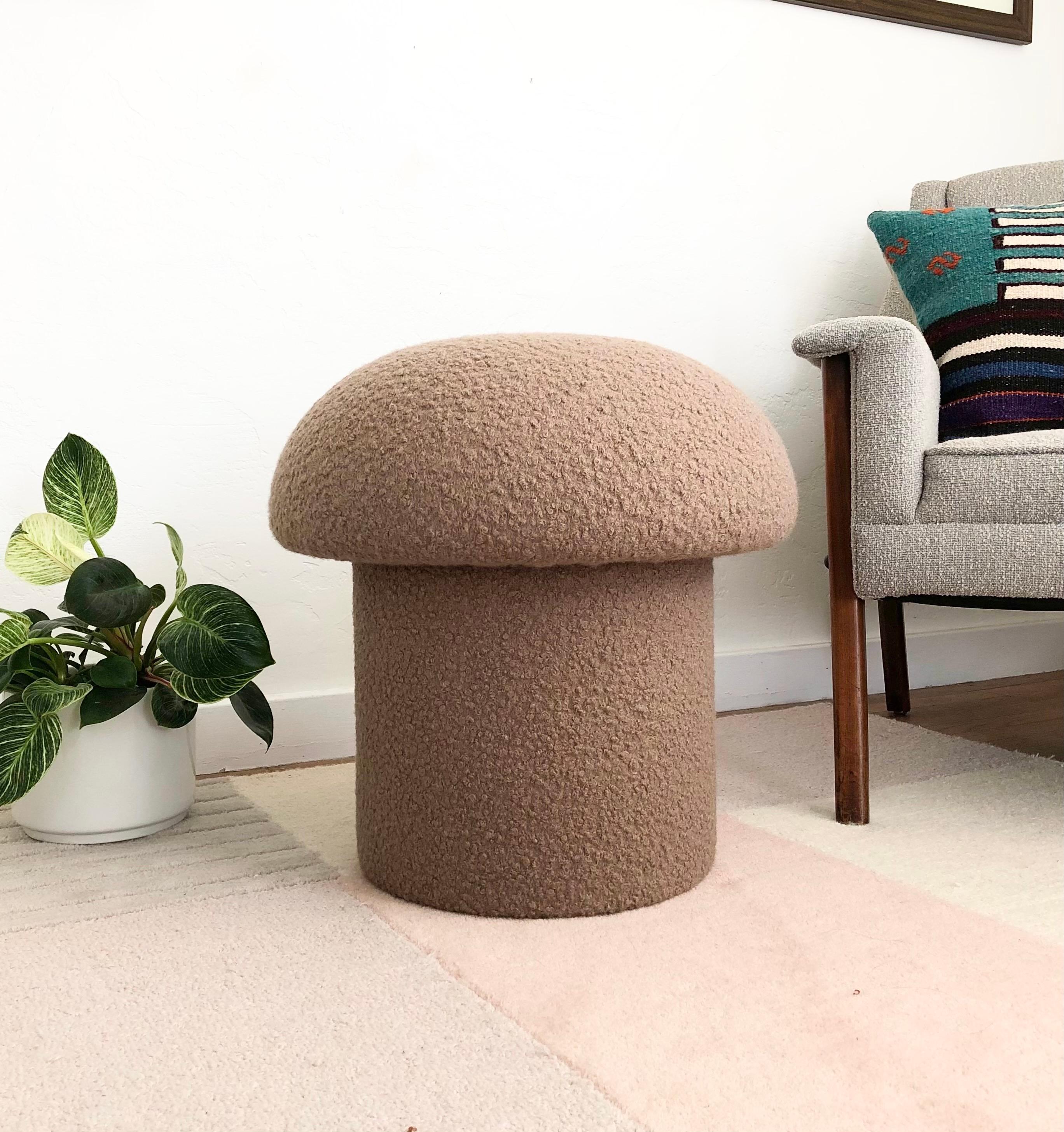 A handmade mushroom shaped ottoman, upholstered in a taupe colored curly boucle fabric. Perfect for using as a footstool or extra occasional seating. A comfortable cushioned seat and sculptural accent piece.
Mushroom ottomans are made to order,