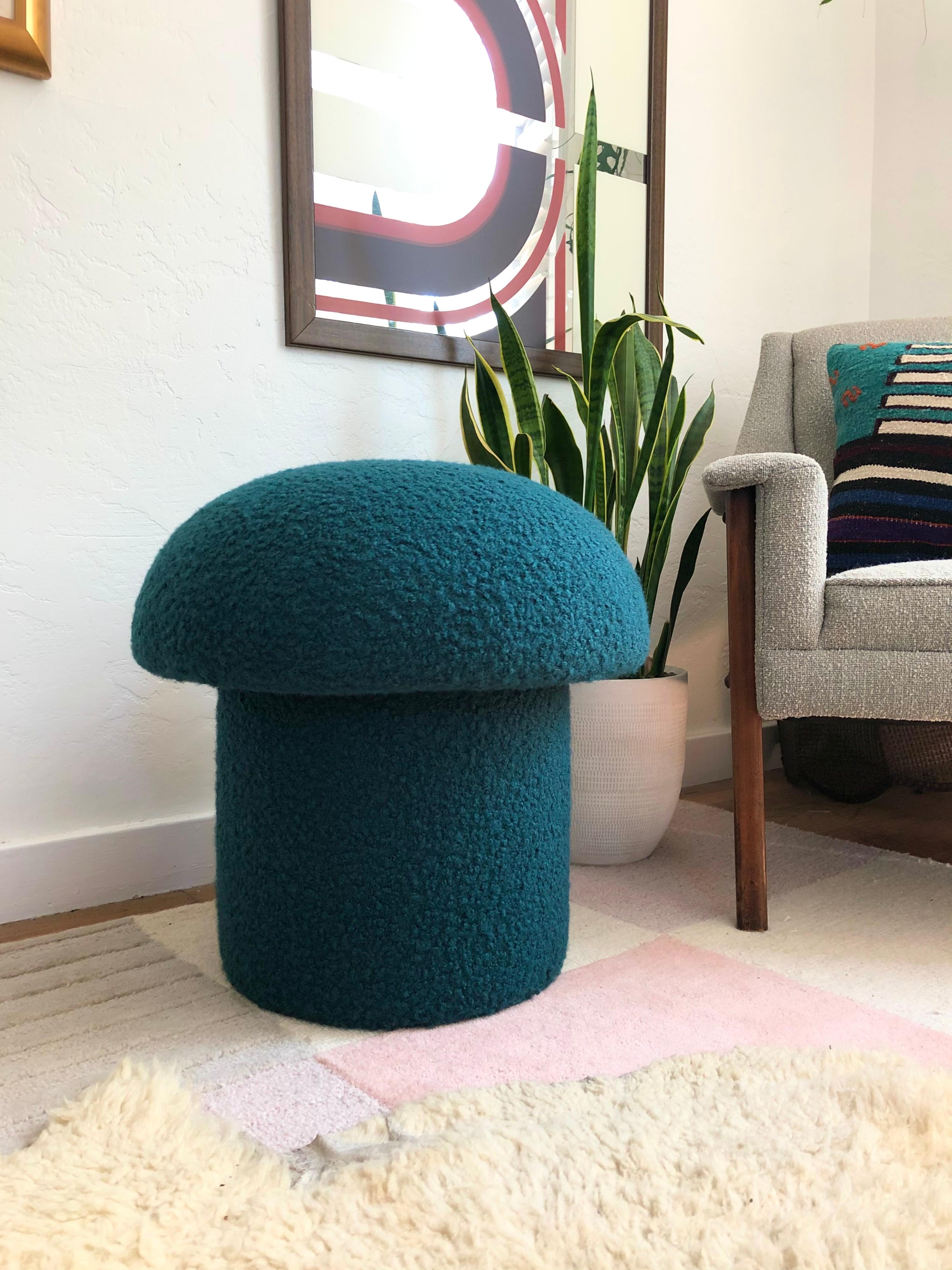 A handmade mushroom shaped ottoman, upholstered in a dark teal colored curly boucle fabric. Perfect for using as a footstool or extra occasional seating. A comfortable cushioned seat and sculptural accent piece.
Mushroom ottomans are made to order,