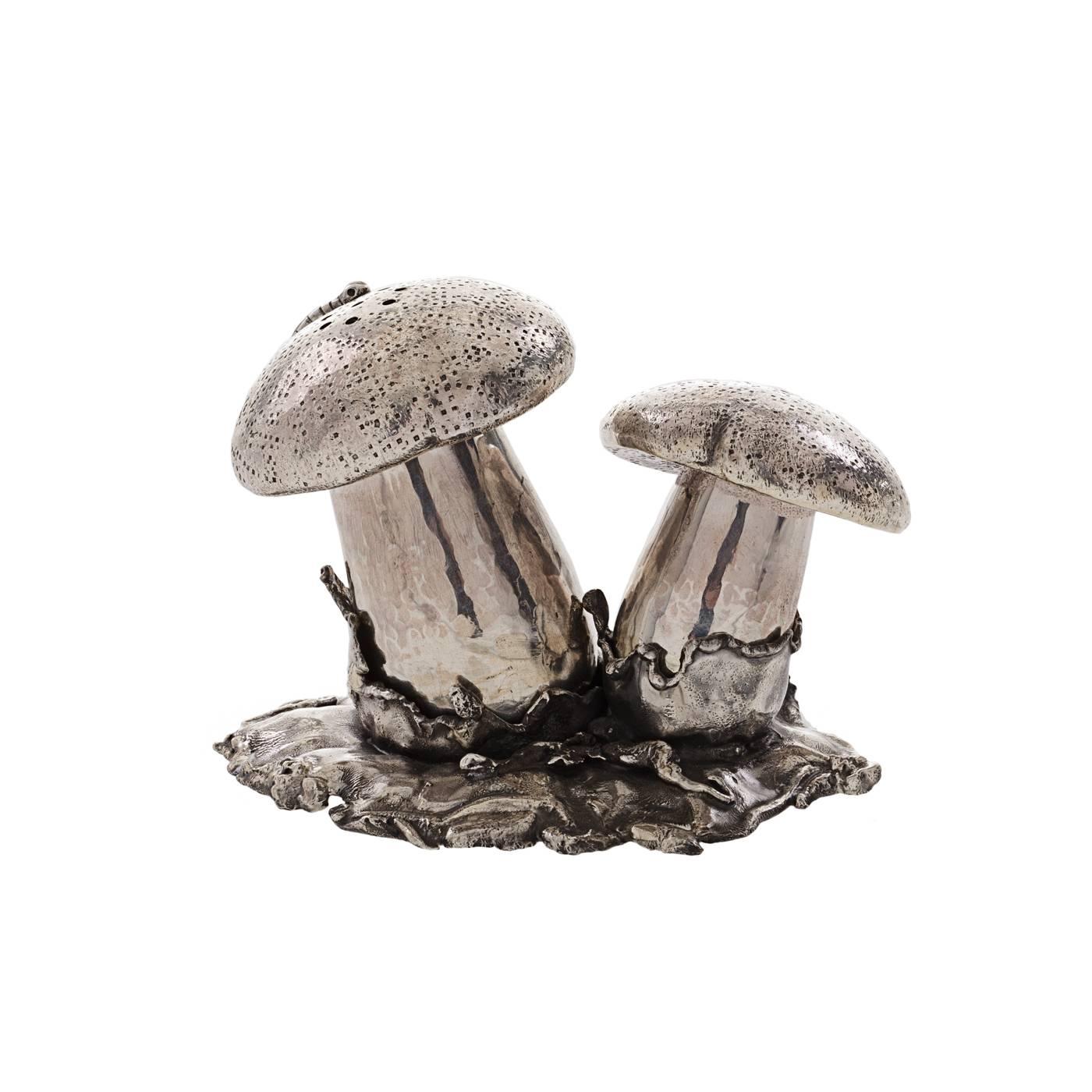 Sterling silver salt and pepper shakers shaped like two wild forest mushrooms. Entirely handcrafted by the expert Florentine silversmiths Lisi Brothers, this tableware piece catches attention with its incredible realism and detailing, as well as the