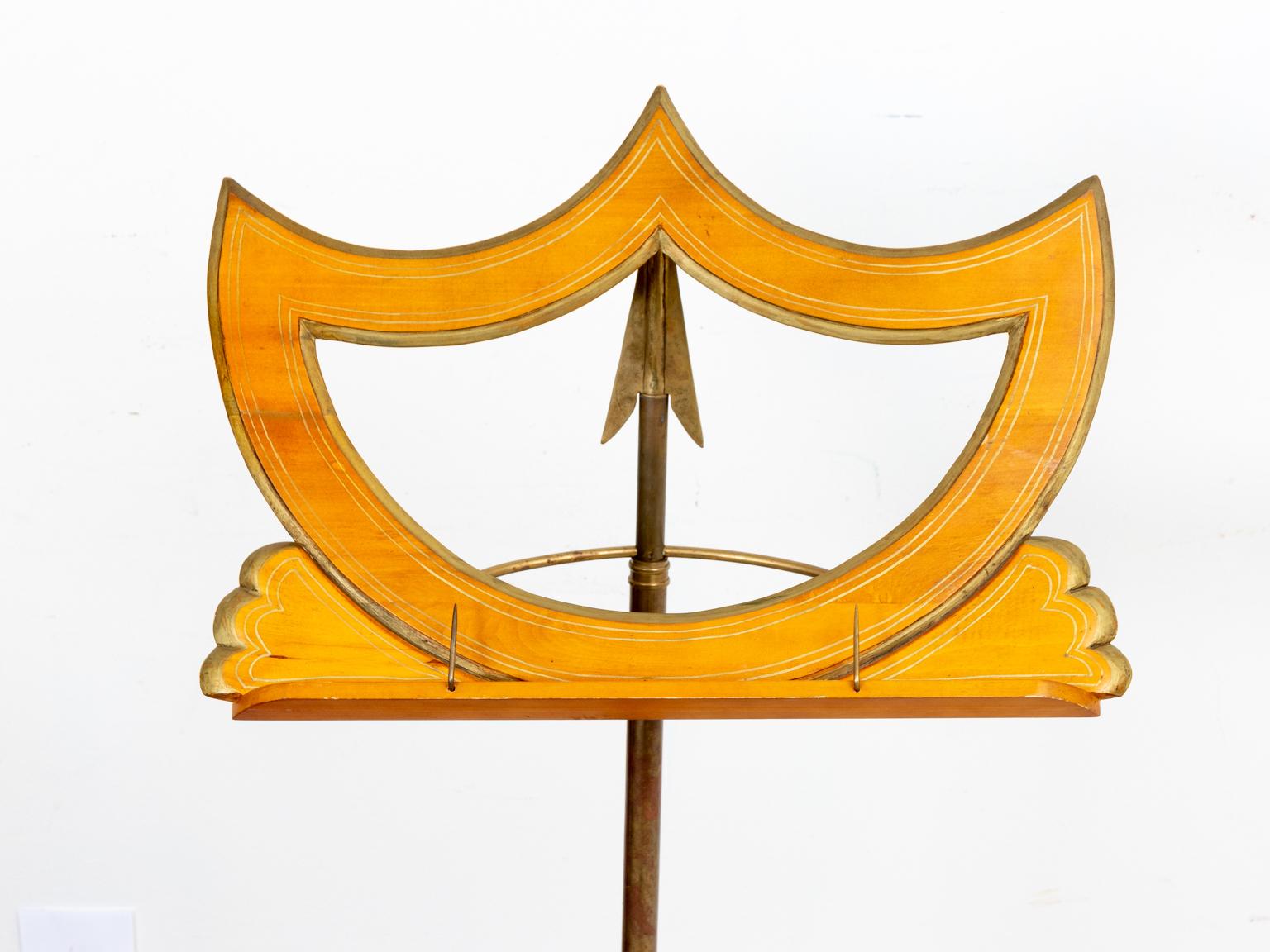 Circa 1990s wooden crest shaped music stand with brass pointed arrow shaped base. Please note of wear consistent with age. 