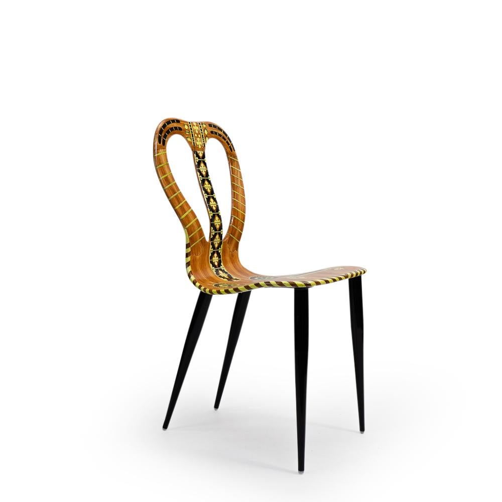 A Musicale chair by Piero Fornasetti, produced by Atelier Fornasetti during the early 1990s.

The Fornasetti company is specialized in handmade furniture and homewares, which it has been producing since the establishment of the brand during the