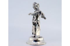 Musician playing violin standing on round, beaded base
