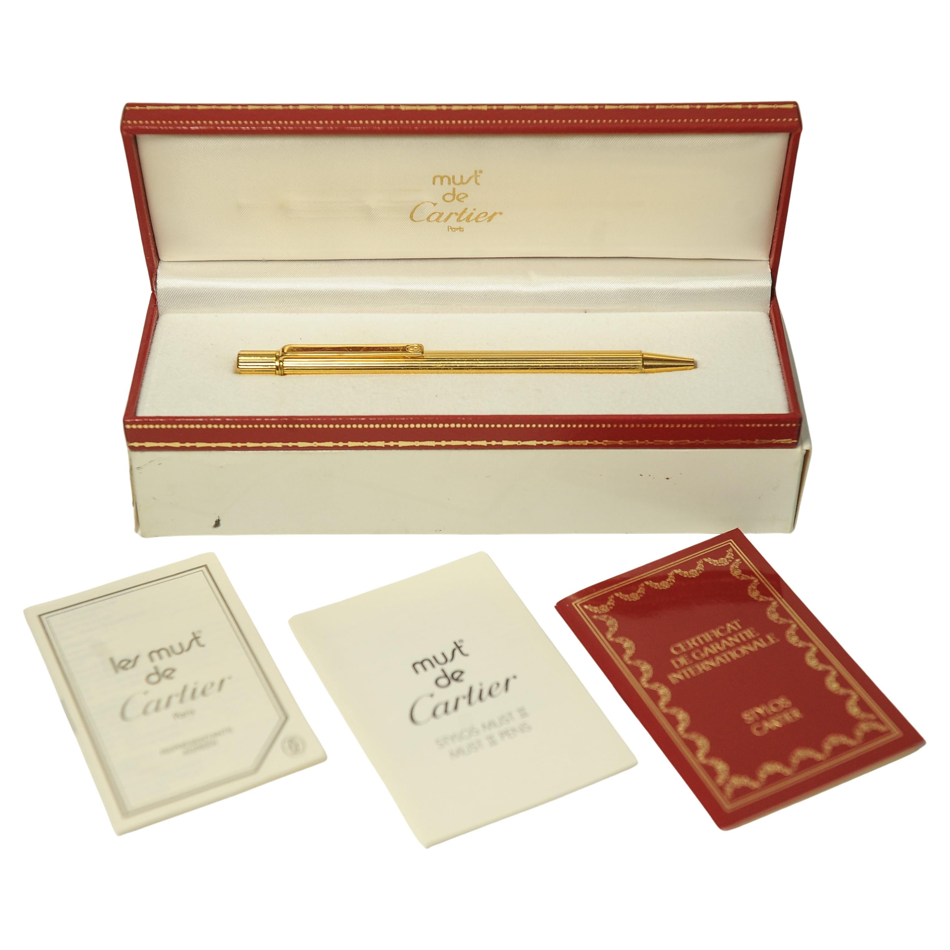 Must de Cartier 18ct Gold Plated Ribbed Ballpoint Pen Made in Paris, France With Original Red & Gold Leather Box, & Certificate 

Serial ref 137564

