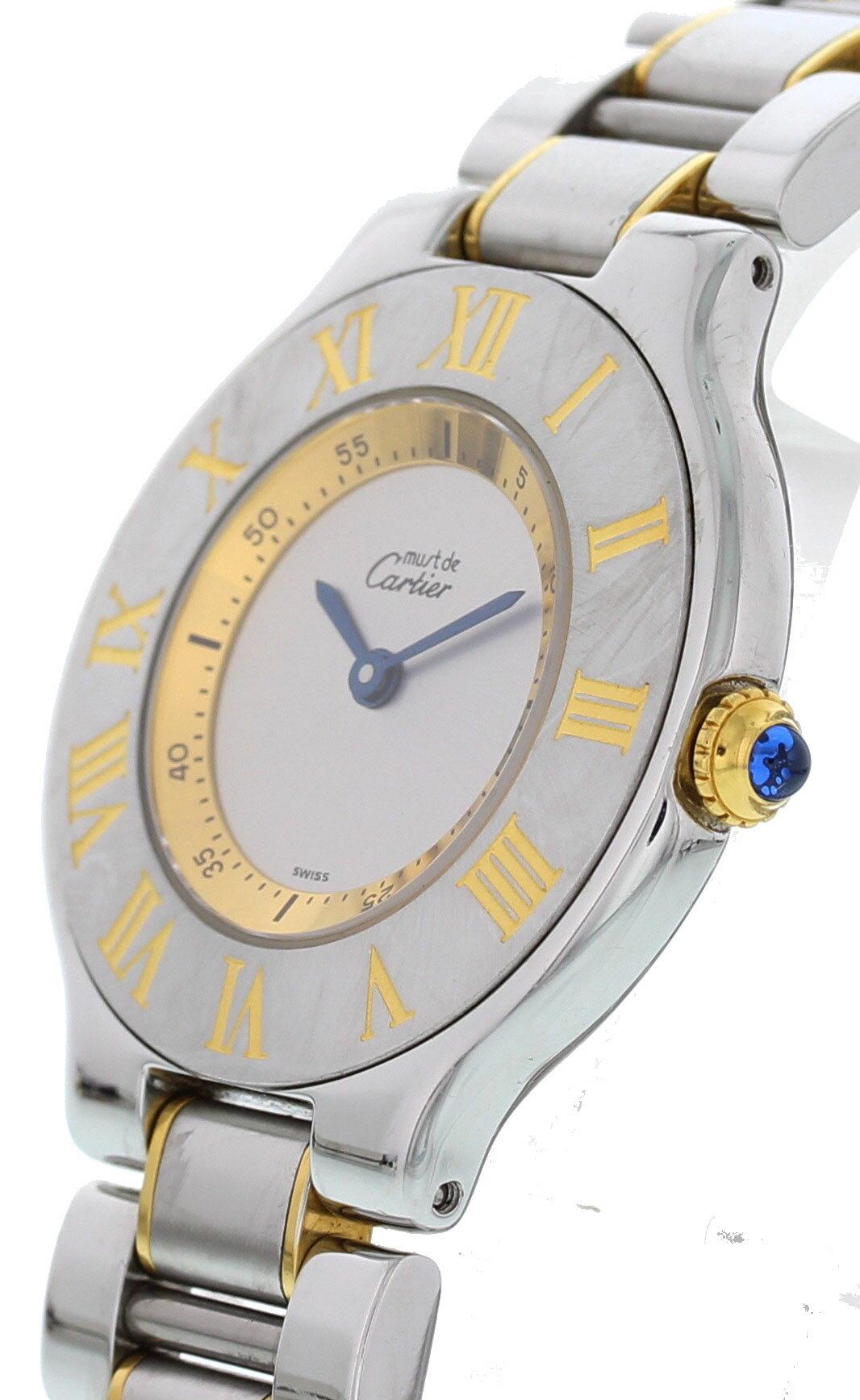 Ladies Must de Cartier 21 1330. 31 mm stainless steel case. Stainless steel bezel with yellow gold Roman numeral markers. Silver dial with blue hands and black markers. Blue sapphire cabochon crown. Stainless steel and 18k yellow gold band with a