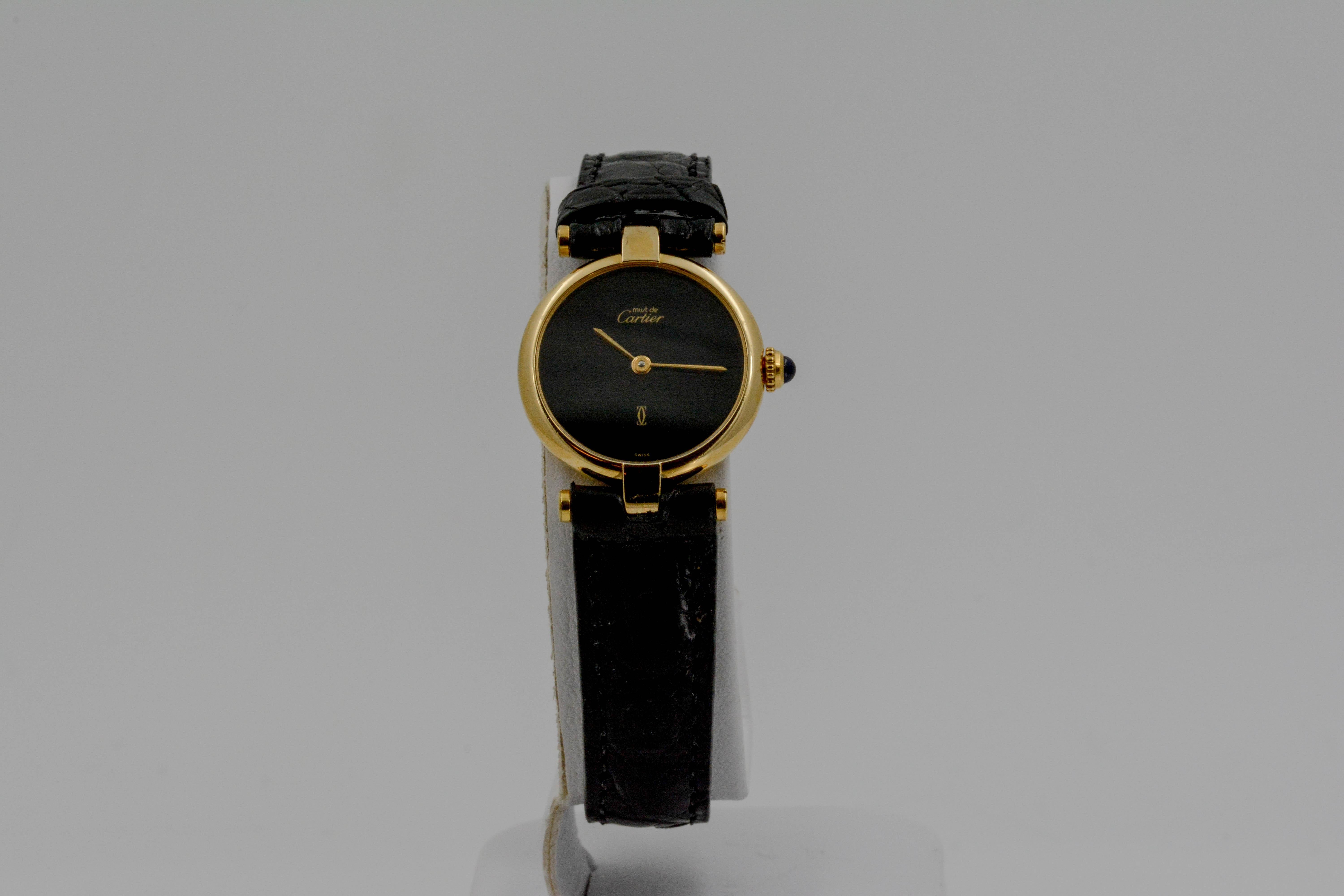 • Model: Must de Cartier 
• Movement: Quartz  
• Case Size: 26mm 
• Case Material: Silver with yellow gold plating (vermeil) 
• Dial: Black dial 
• Strap: Black alligator leather 
• Closure/Clasp Type: Yellow gold plated tang buckle 
• CIRCA 1990’s;