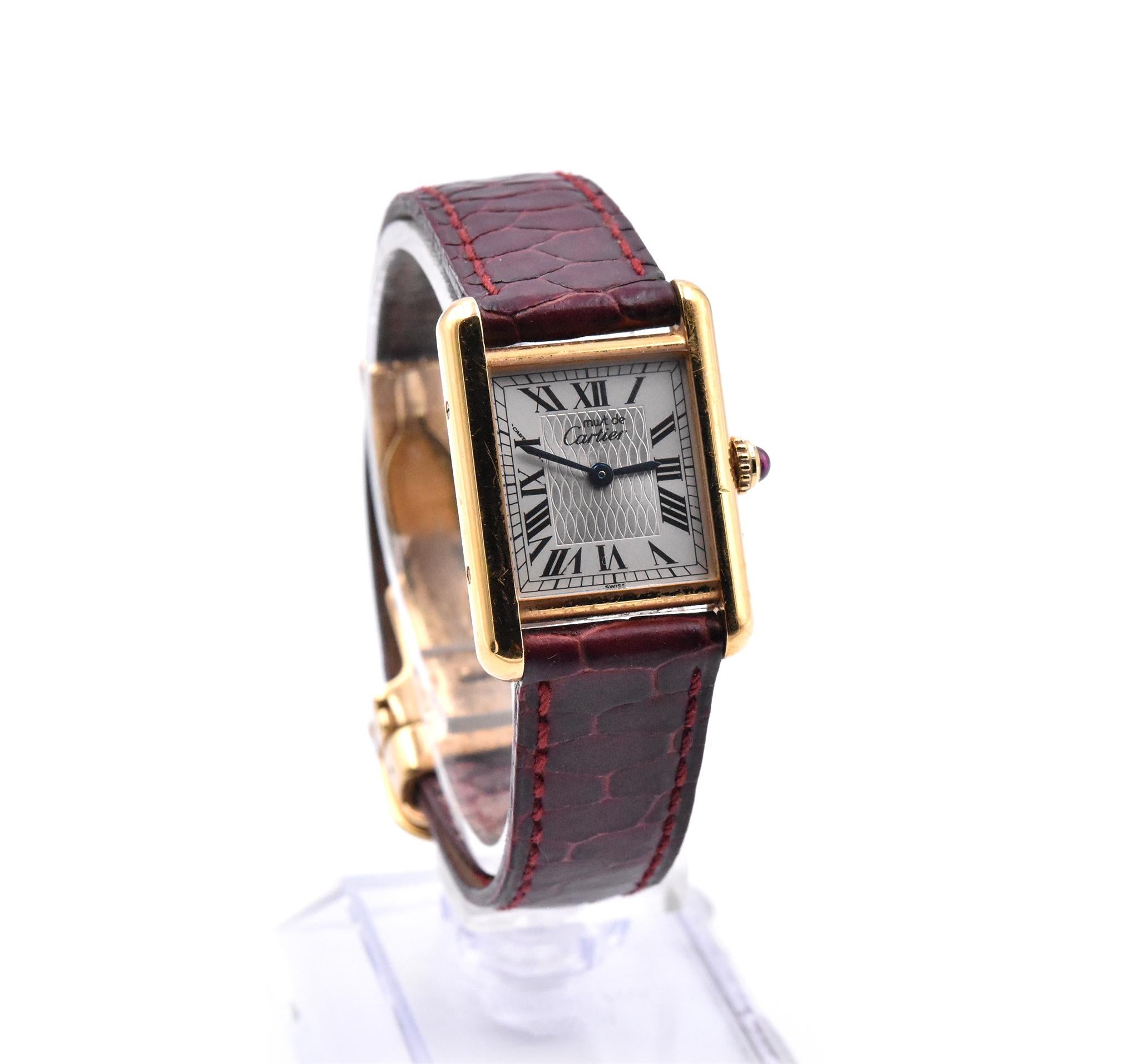 Movement: quartz
Function: hours, minutes
Case: 20mm x 28mm rectangular case, cabochon ruby screw down crown
Dial: silver dial with roman numeral hour markers, blue steel hands
Band: factory Cartier leather strap with deployment buckle
Serial #: