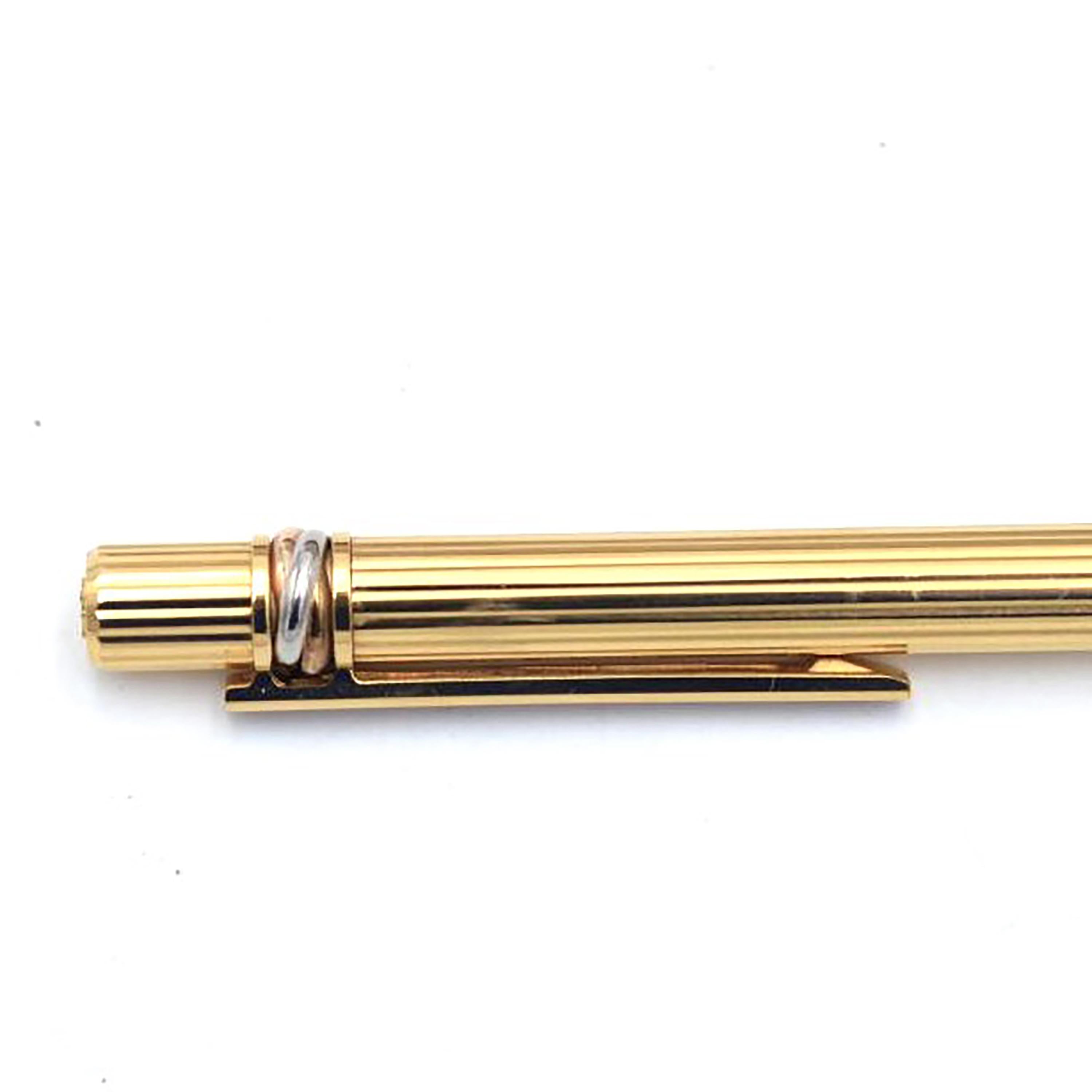 Indulge in the timeless allure of the Must De Cartier Gold-Plated Ballpoint Pen, a masterpiece that seamlessly blends opulence and functionality. Crafted with precision and bearing the esteemed Cartier legacy, this pen is not just a writing