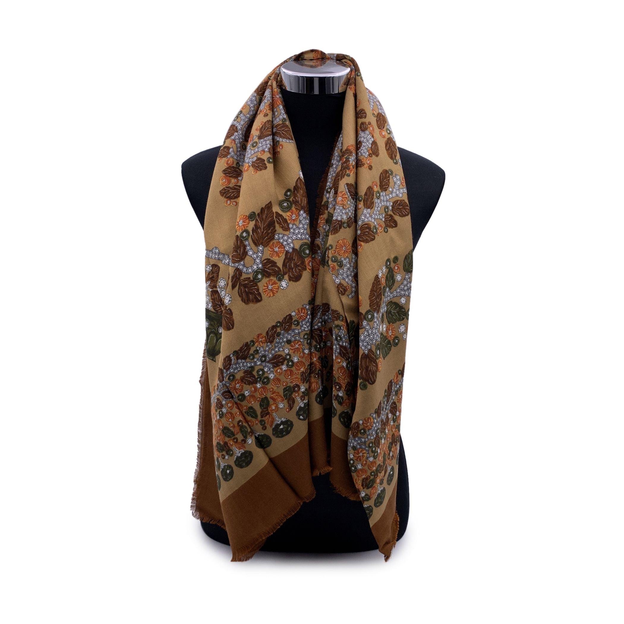 Beautiful Must de Cartier vintage maxi shawl. Composition: 40% wool, 60% Silk. Jewels and leaves design. Brown colorway. Frayed edges. Composition tag is still attached. Measurements: 55 x 55 inches - 139.7 x 139.7 cm Condition A - EXCELLENT Gently