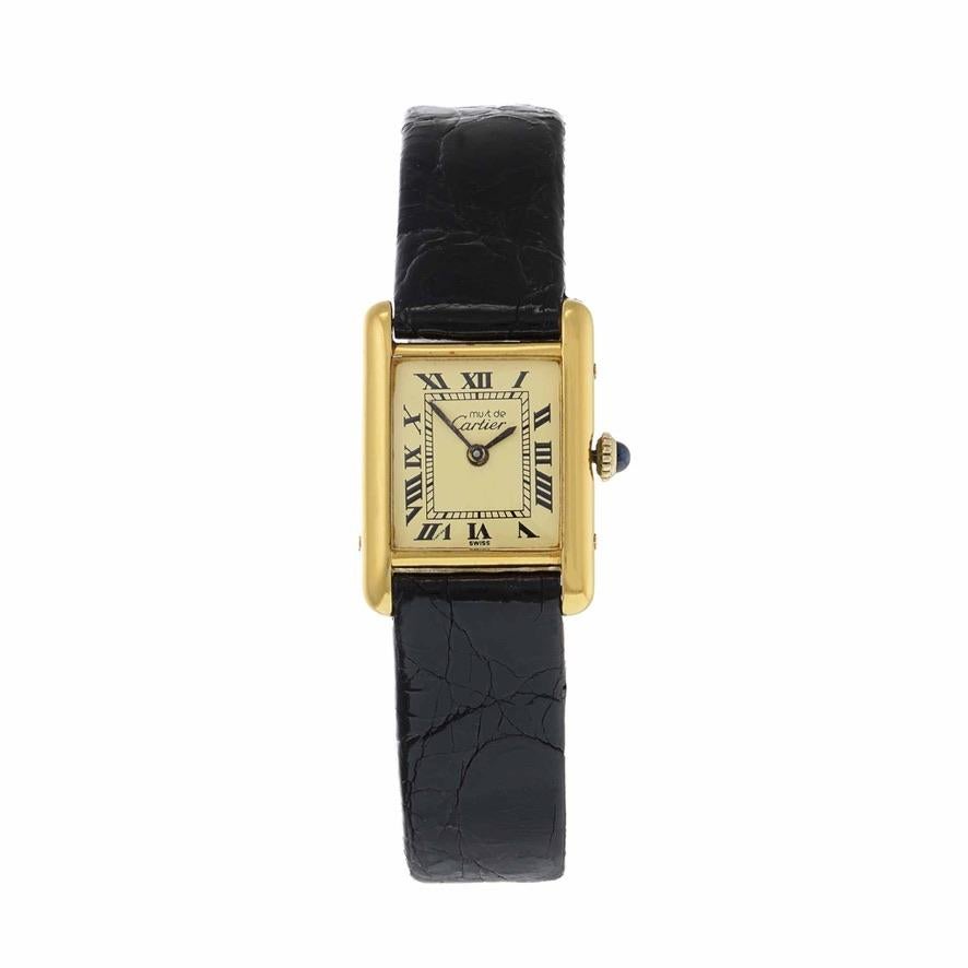 This is an excellent vintage Must de Cartier manual wind vermeil tank watch. This watch is solid sterling silver with gold overlay. The dial is champagne in color and has the Cartier logo embedded within the VII marker. 

The case of this watch