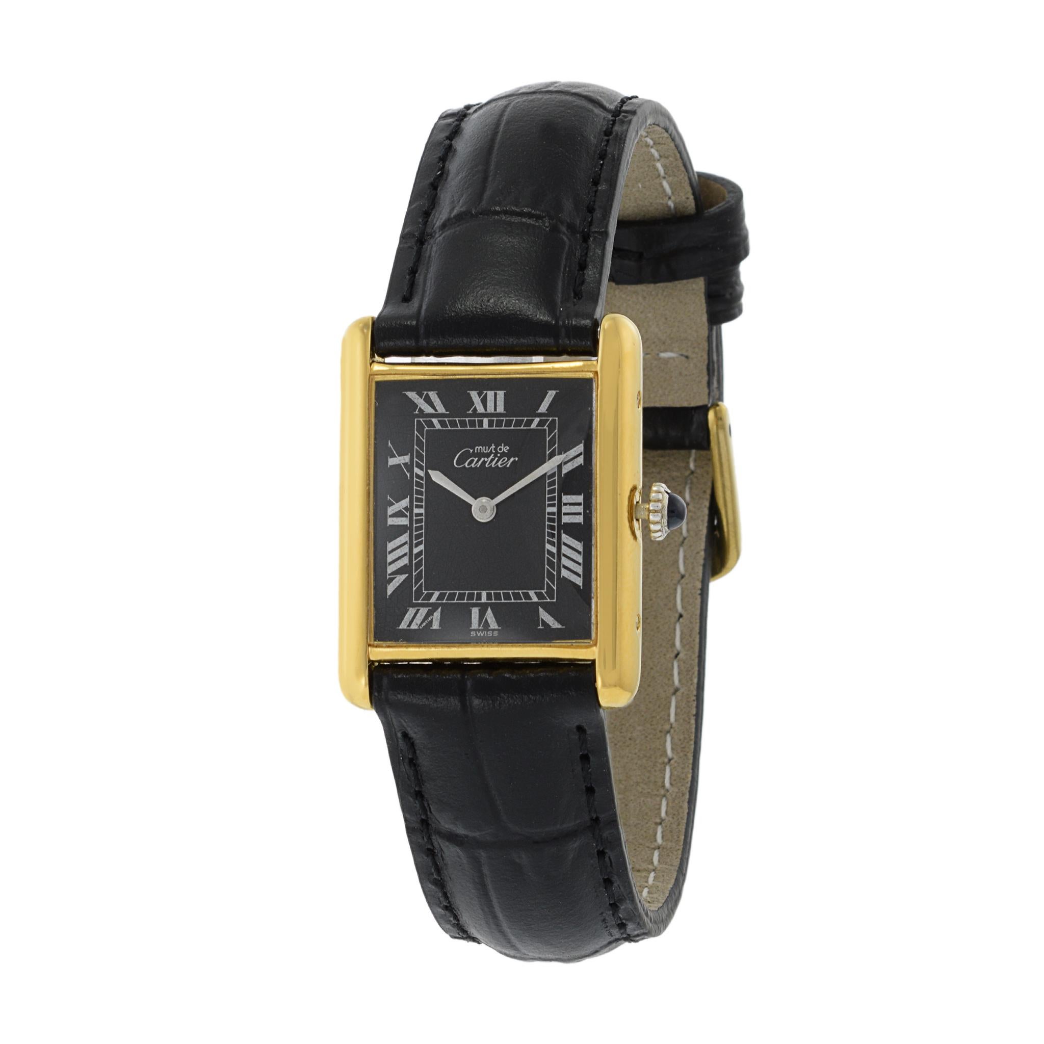 This is a great condition 1970's Must de Cartier Vermeil tank watch. The watch is powered by a manual wind movement. The case of the watch measures 23.5mm x 30.5mm and is sterling silver overlayed with yellow gold.

The dial of the watch is black