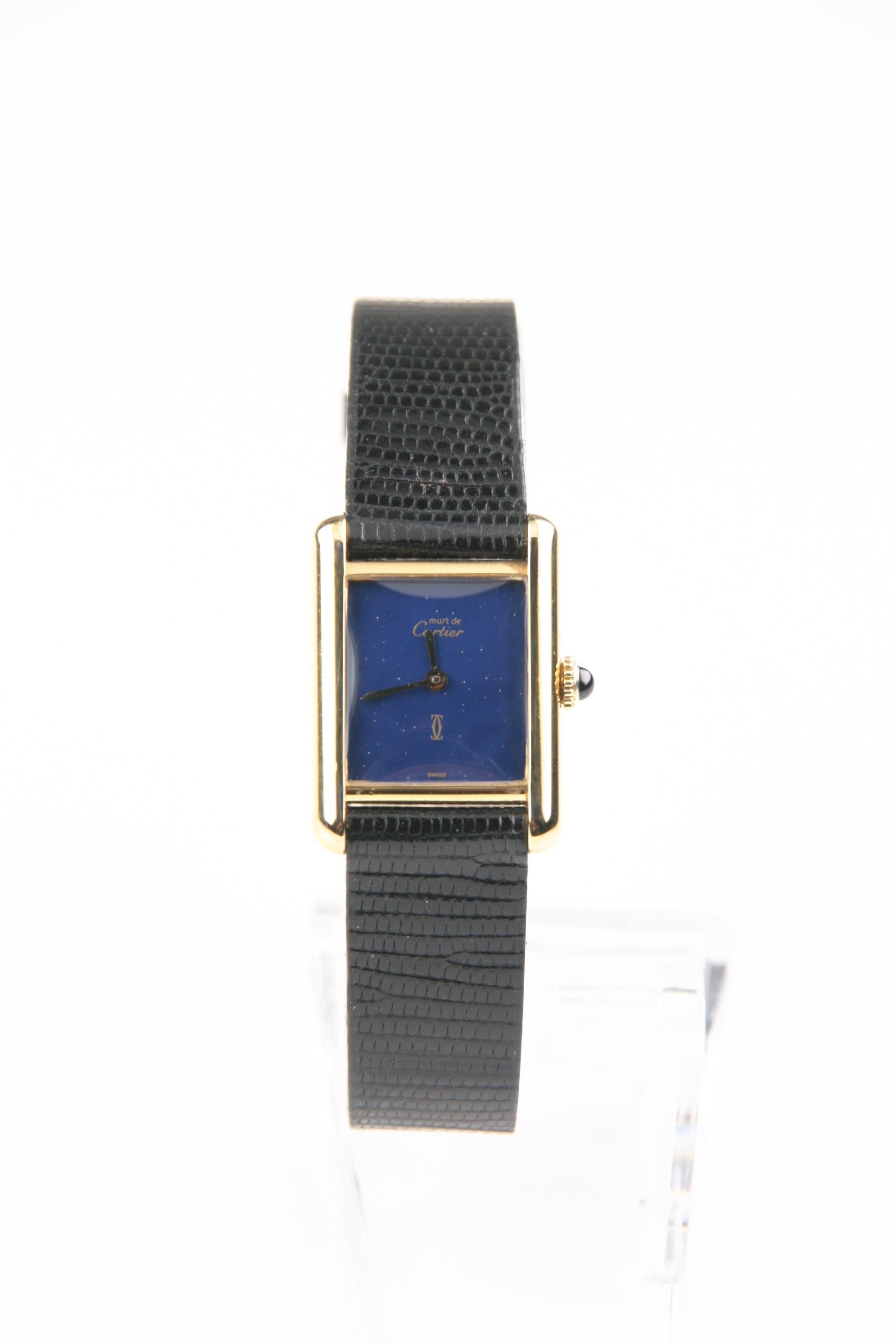 Case #3185620
Movement #2512-1
Gold-Plated Sterling Silver Must de Cartier Case w/ Sapphire Cabochon Crown
20 mm Wide (23 mm w/ Crown)
20 mm Long
Lug-to-Lug Distance = 27 mm
Rare Navy Blue Dial w/ Gold Specks & Gold Hands (M + H)
Labeled 