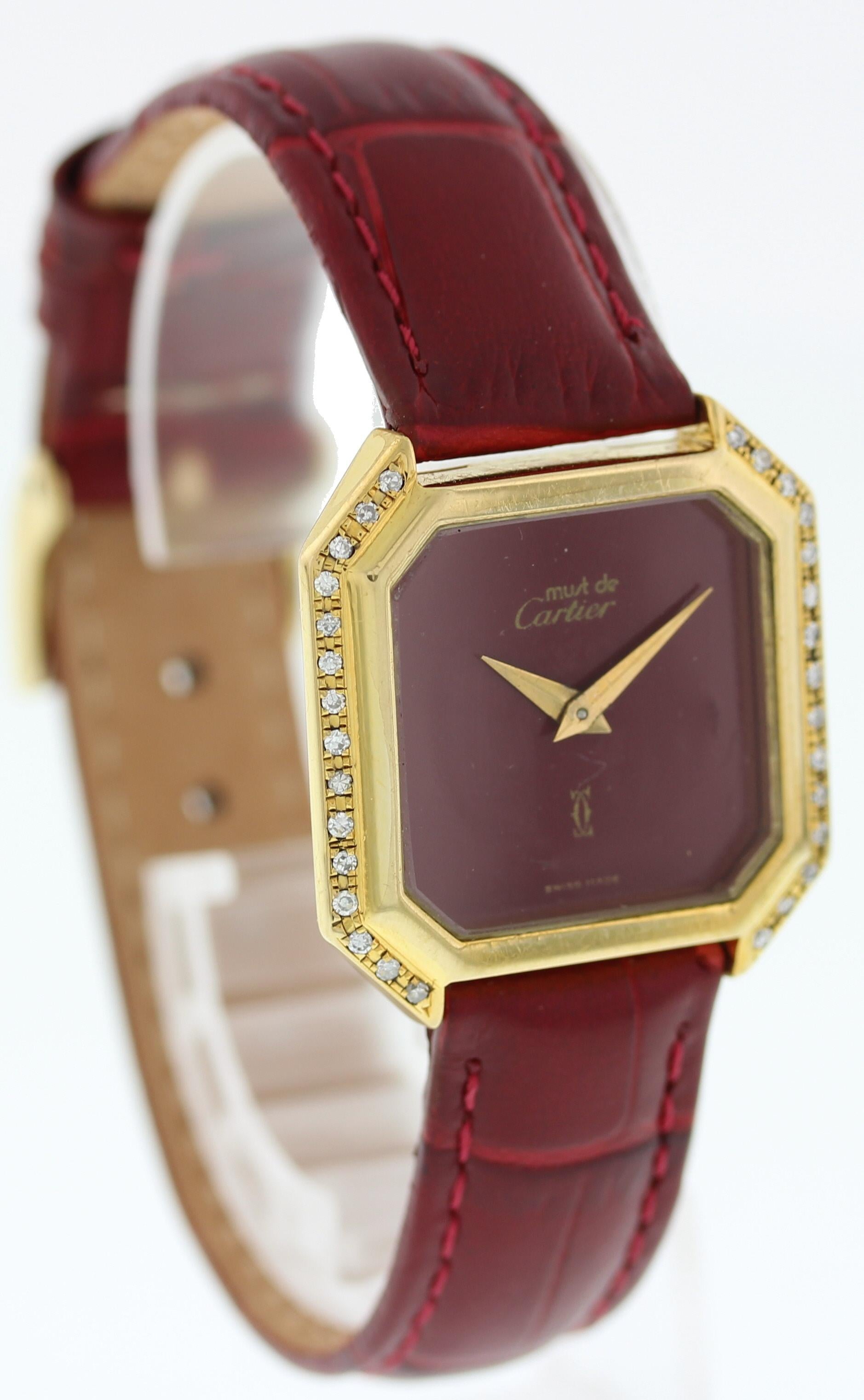 Ladies Vintage Must de Cartier. 27mm electroplated 18k Gold case with custom set diamonds. Red dial and gold hands. Red leather band with gold toned buckle clasp. 

This watch is backed by our one year warranty.