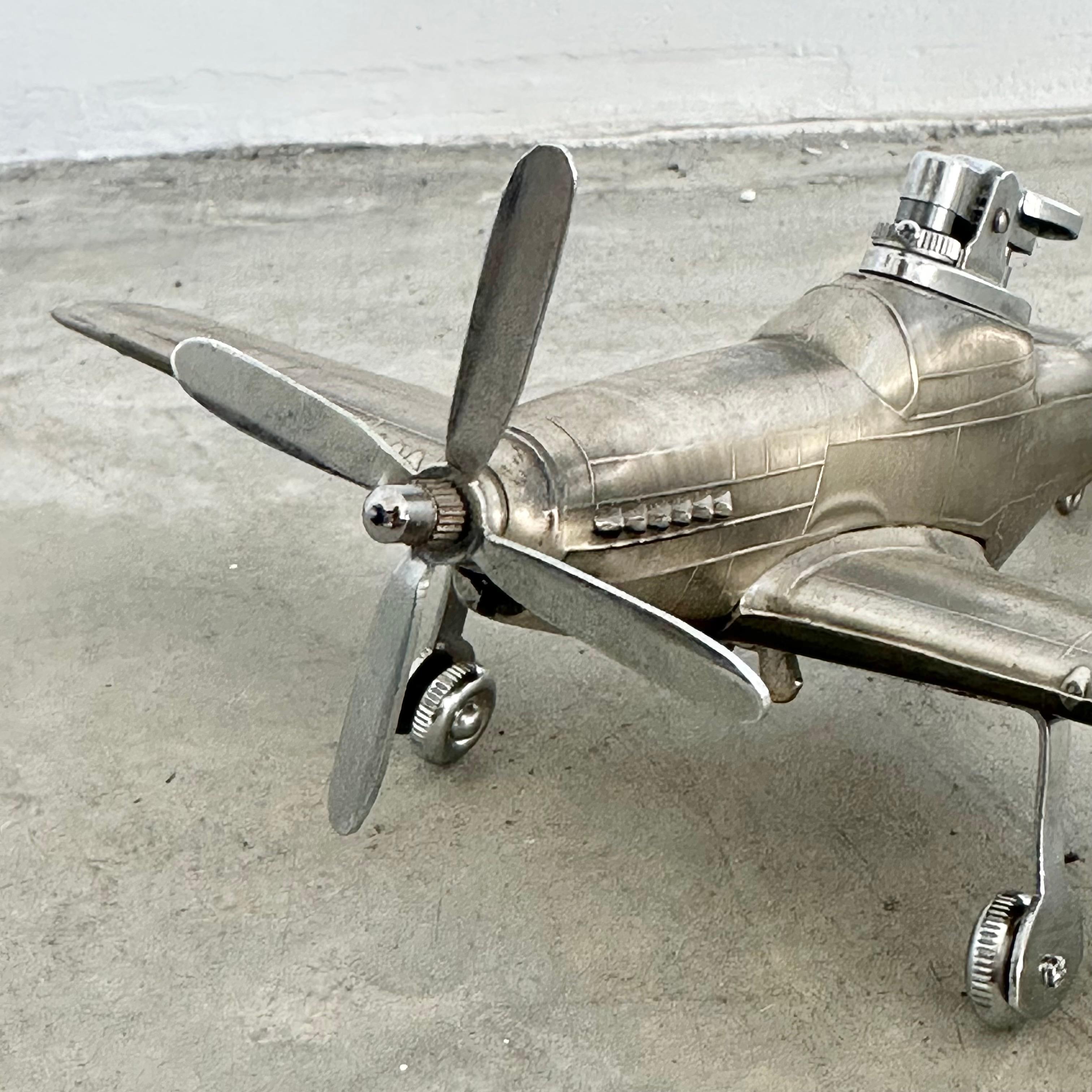 Cool vintage table lighter in the shape of a Mustang airplane. Made of metal with 