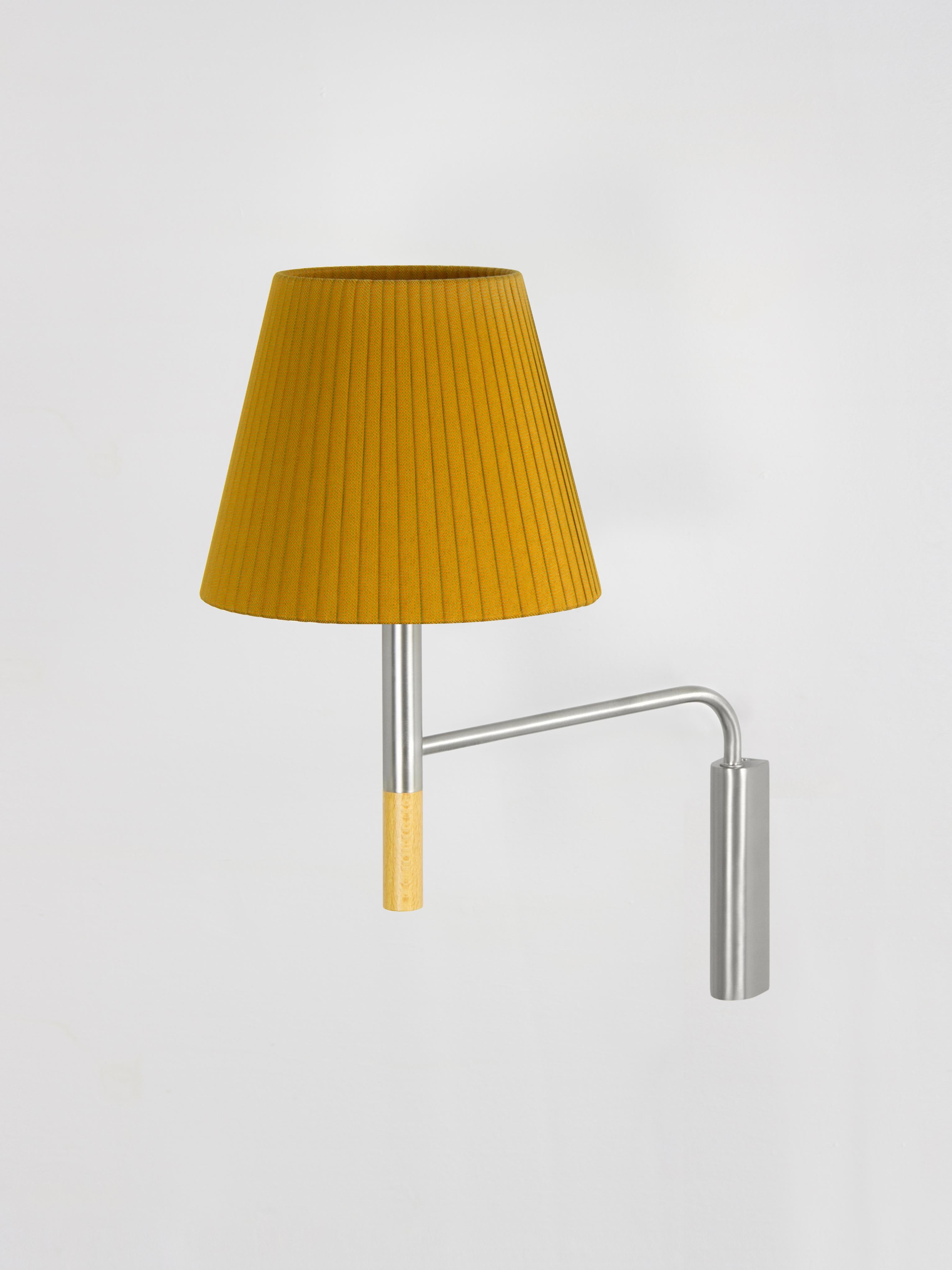 Mustard BC3 wall lamp by Santa & Cole
Dimensions: D 20 x W 37 x H 41 cm
Materials: Metal, beech wood, ribbon.

The BC1, BC2 and BC3 wall lamps are the epitome of sturdy construction, aesthetic sobriety and functional quality. Their various shade