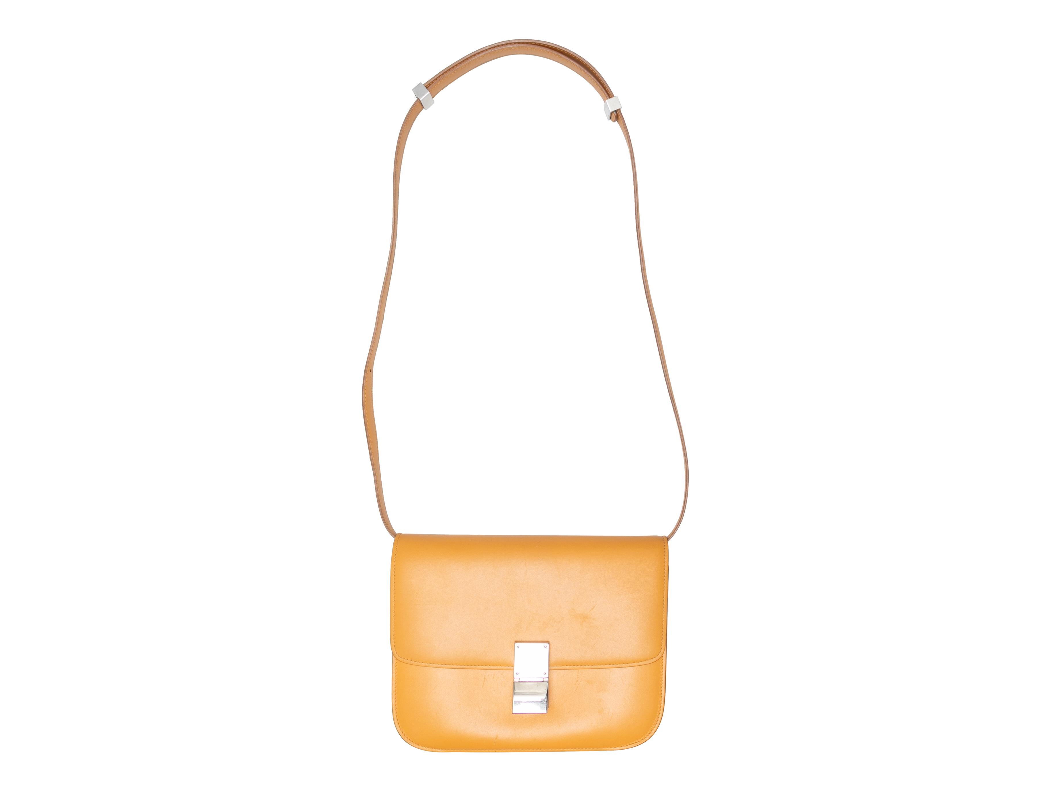  Mustard Celine Teen Classic Leather Crossbody. The Teen Classic Crossbody features a leather body, silver-tone hardware, a single flat shoulder strap, and a front clasp closure. 9.25