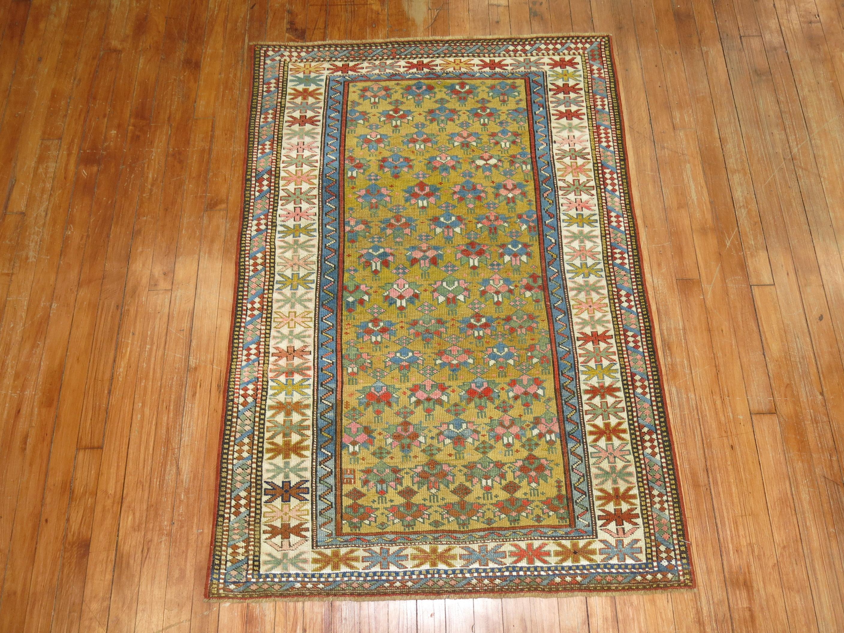 A geometric tribal looking Caucasian Shirvan rug from the late 19th century. Mustard ground, dominant accents in robin eggs blue and pink. The border is ivory

Measures: 3'3” x 4'9”

Antique Caucasian rugs from the Shirvan district village are