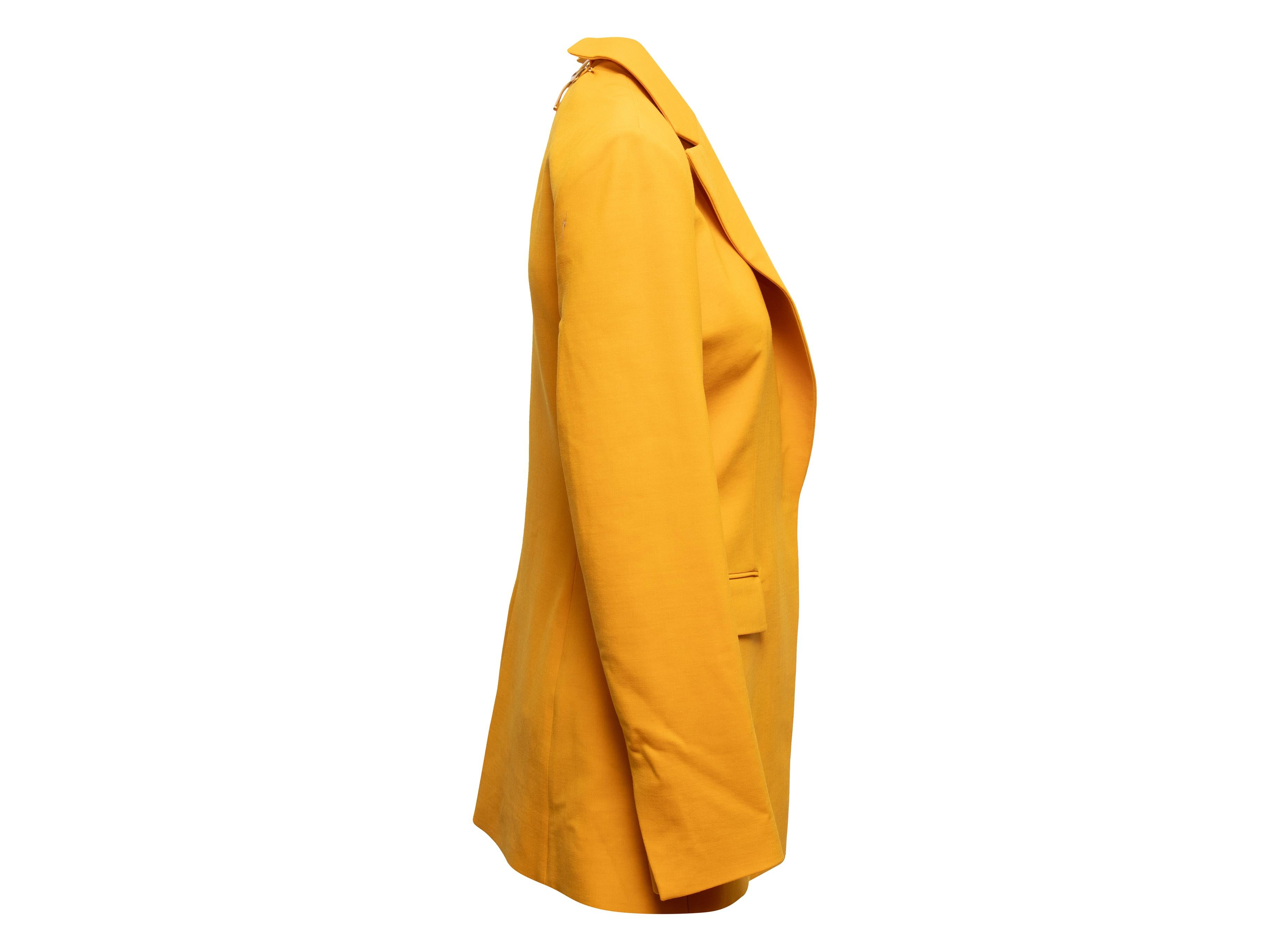 Mustard virgin wool cutout back blazer by Oscar de la Renta. From the Fall 2021 Collection. Notched lapel. Three pockets. Gold-tone metal bow accent at back nape. Concealed front closure. 36