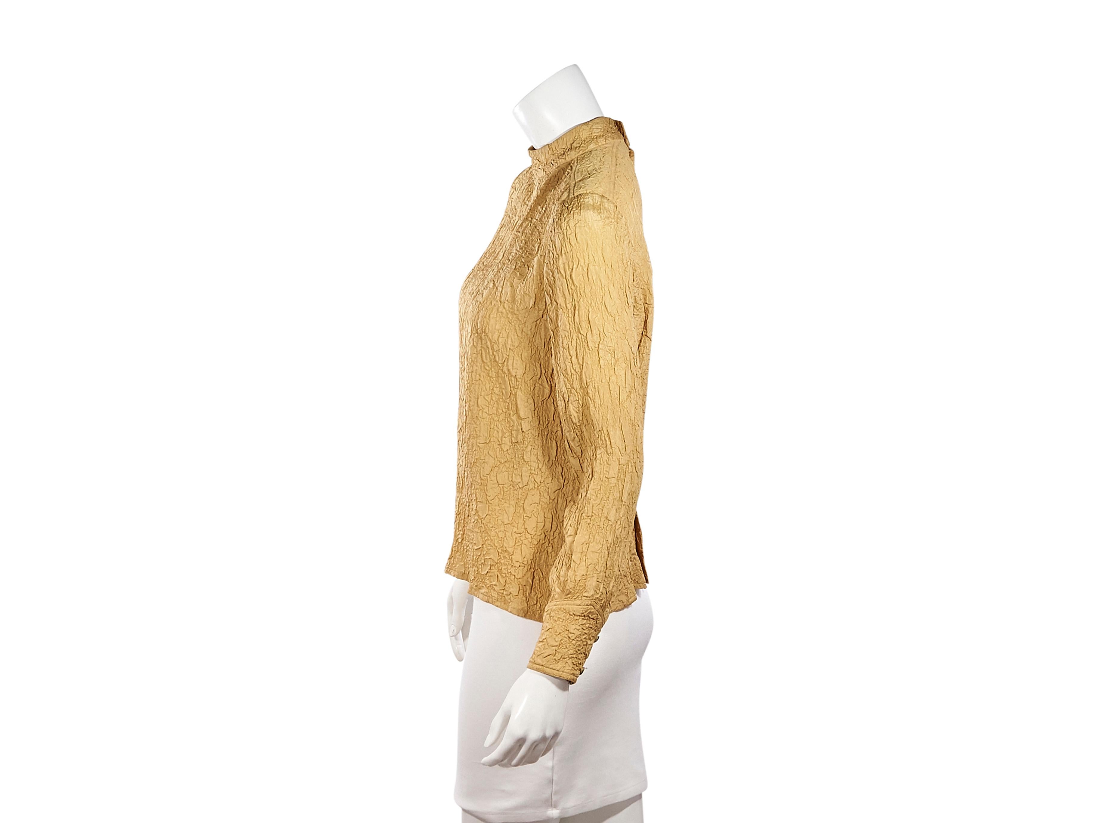 Product details:  Vintage mustard yellow silk crepe blouse by Chanel.  Mock neck.  Long sleeves.  Double-button detail at cuffs.  Button-back closure.  Goldtone hardware.  36